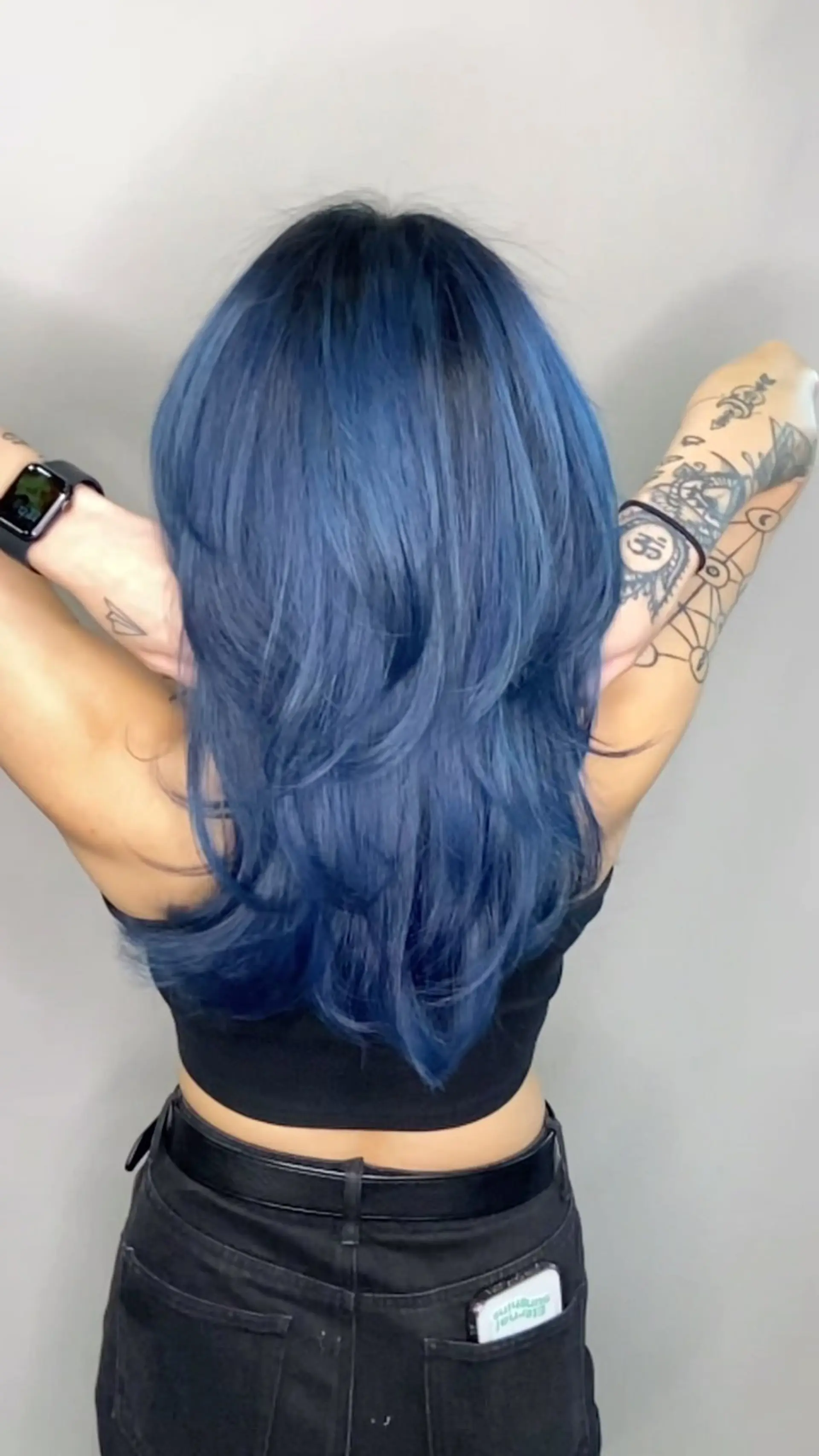 Long layered wolf cut styled in a voluminous blowout with a rich, smoky denim blue vivid tone. 1