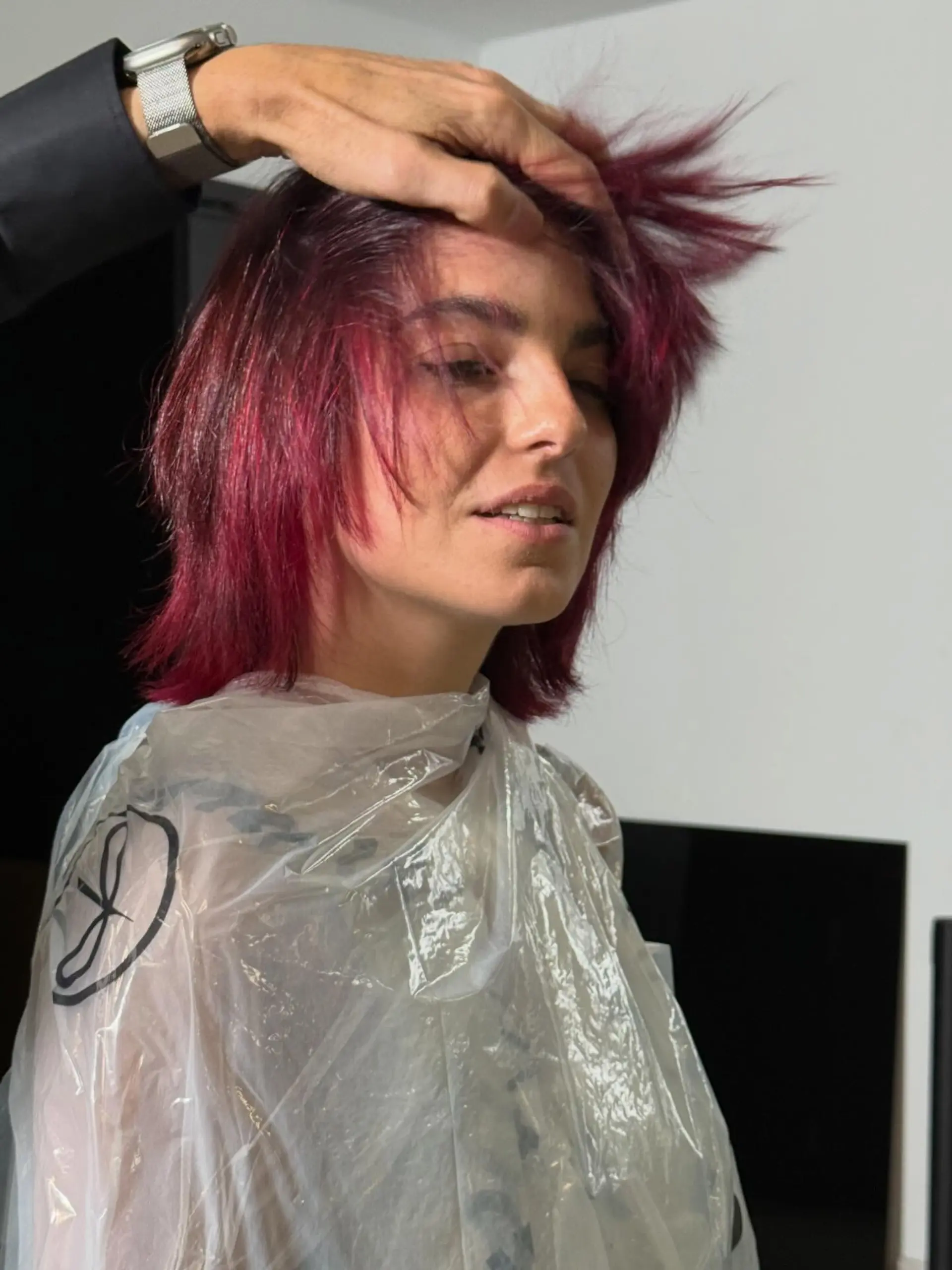 A vibrant magenta textured shag haircut featuring choppy, layered ends and wispy bangs. 1
