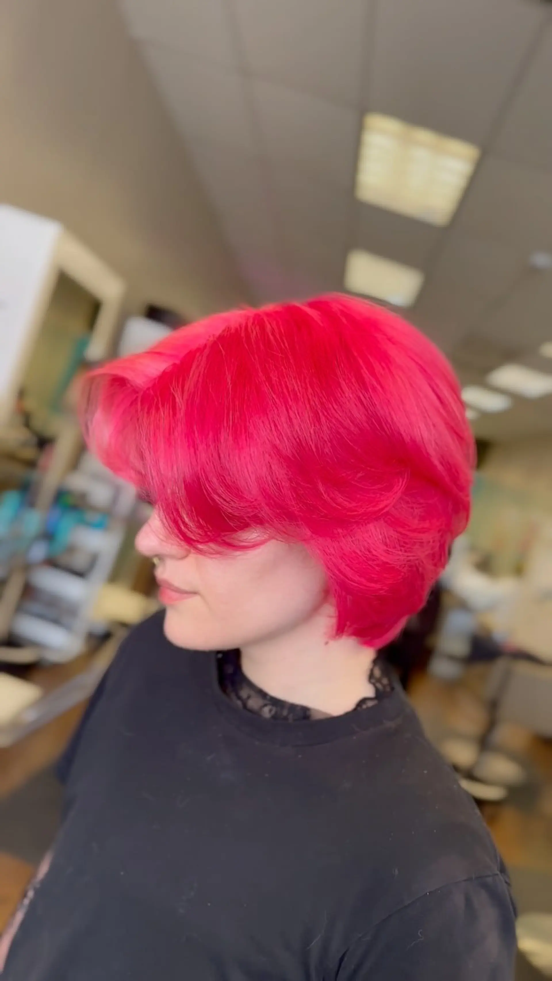 Vibrant neon hot pink feathered short bob with layered side-swept bangs. 1