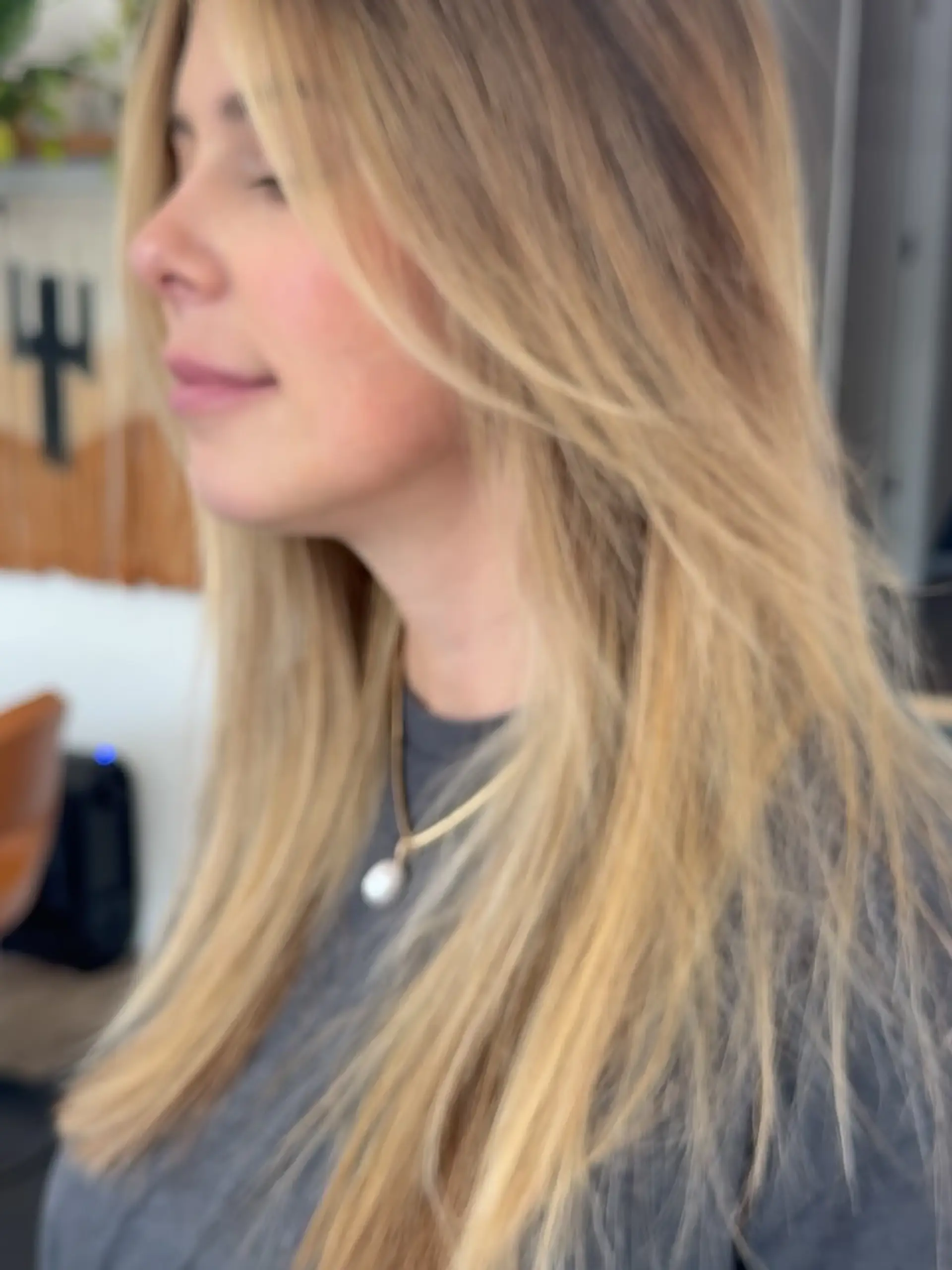 Long honey blonde hair cut with soft, face-framing layers and styled in a relaxed, natural blowout. 1