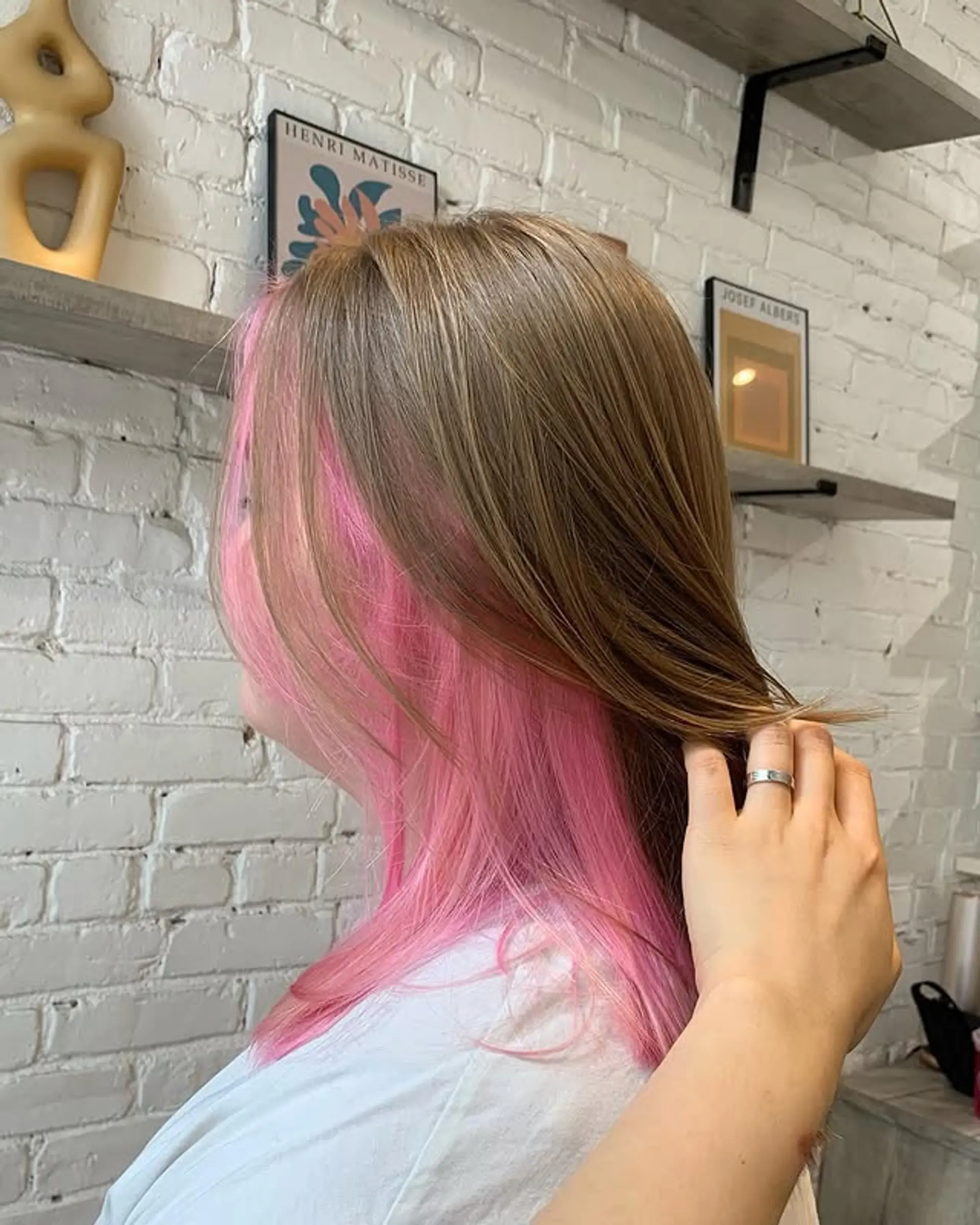 Medium-length straight hair with face-framing 'money piece' highlights in a vibrant pink color. 1