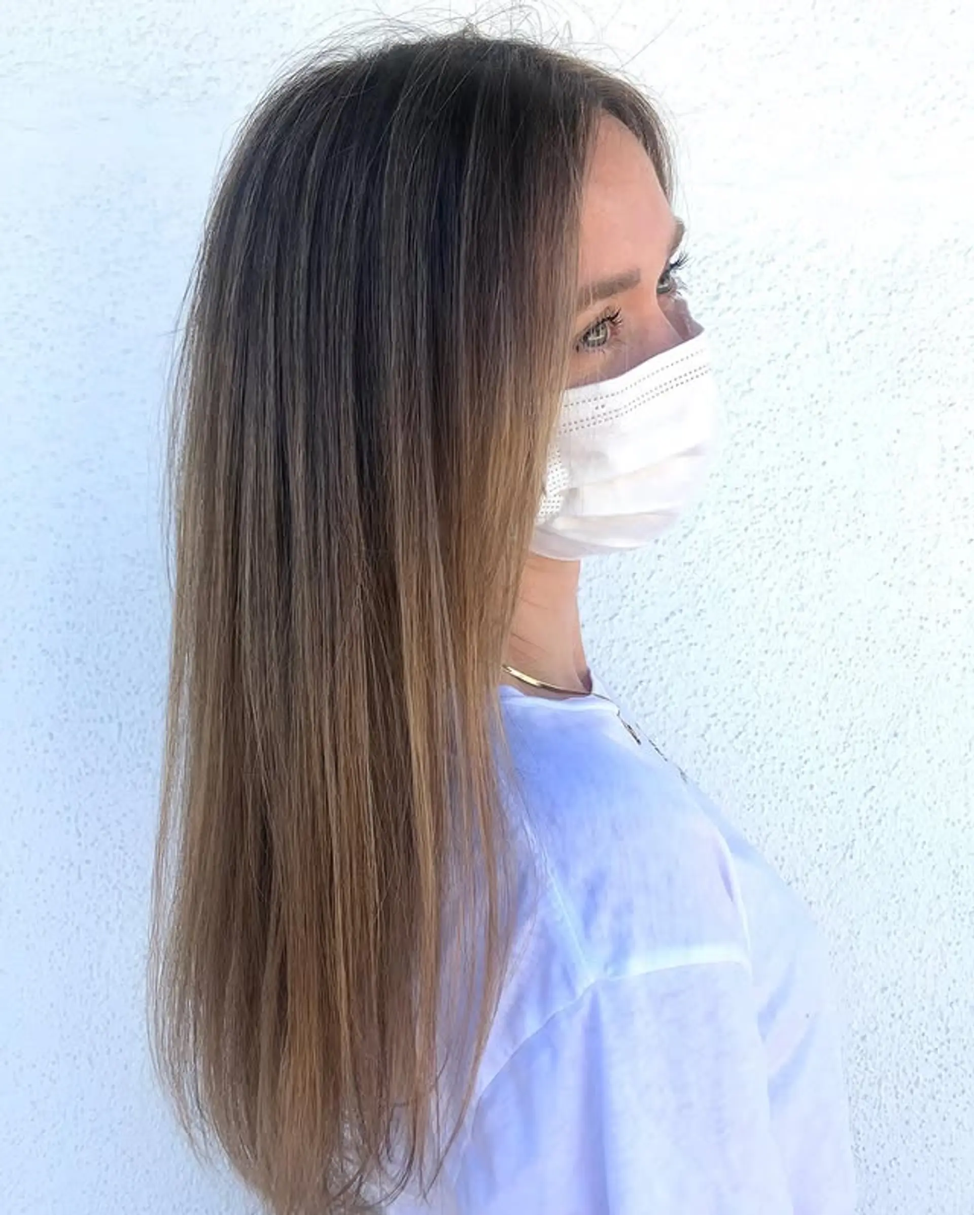 A long, straight hairstyle featuring a beautiful brunette to blonde balayage. 1
