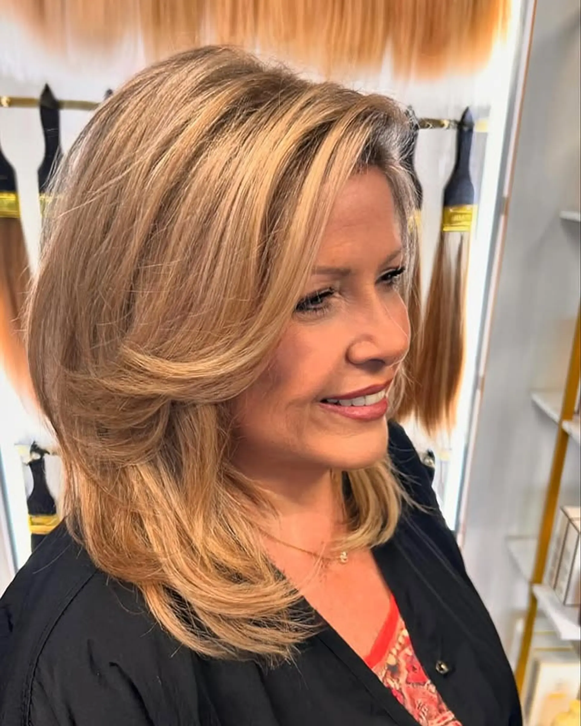 A layered medium haircut with face-framing layers and a voluminous blowout. 1