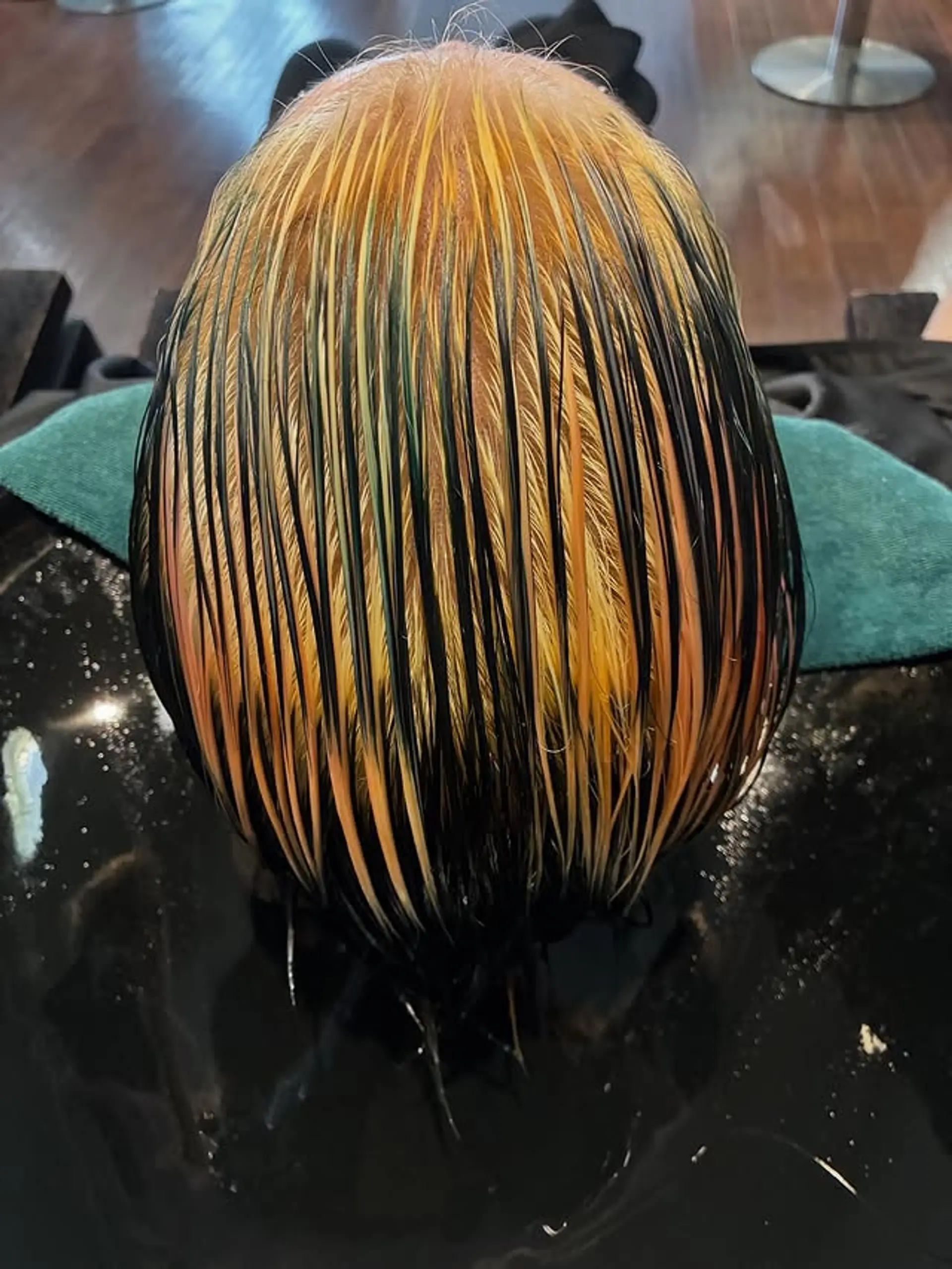 A rooted ombre with dark roots fading into a blend of orange and blonde. 1