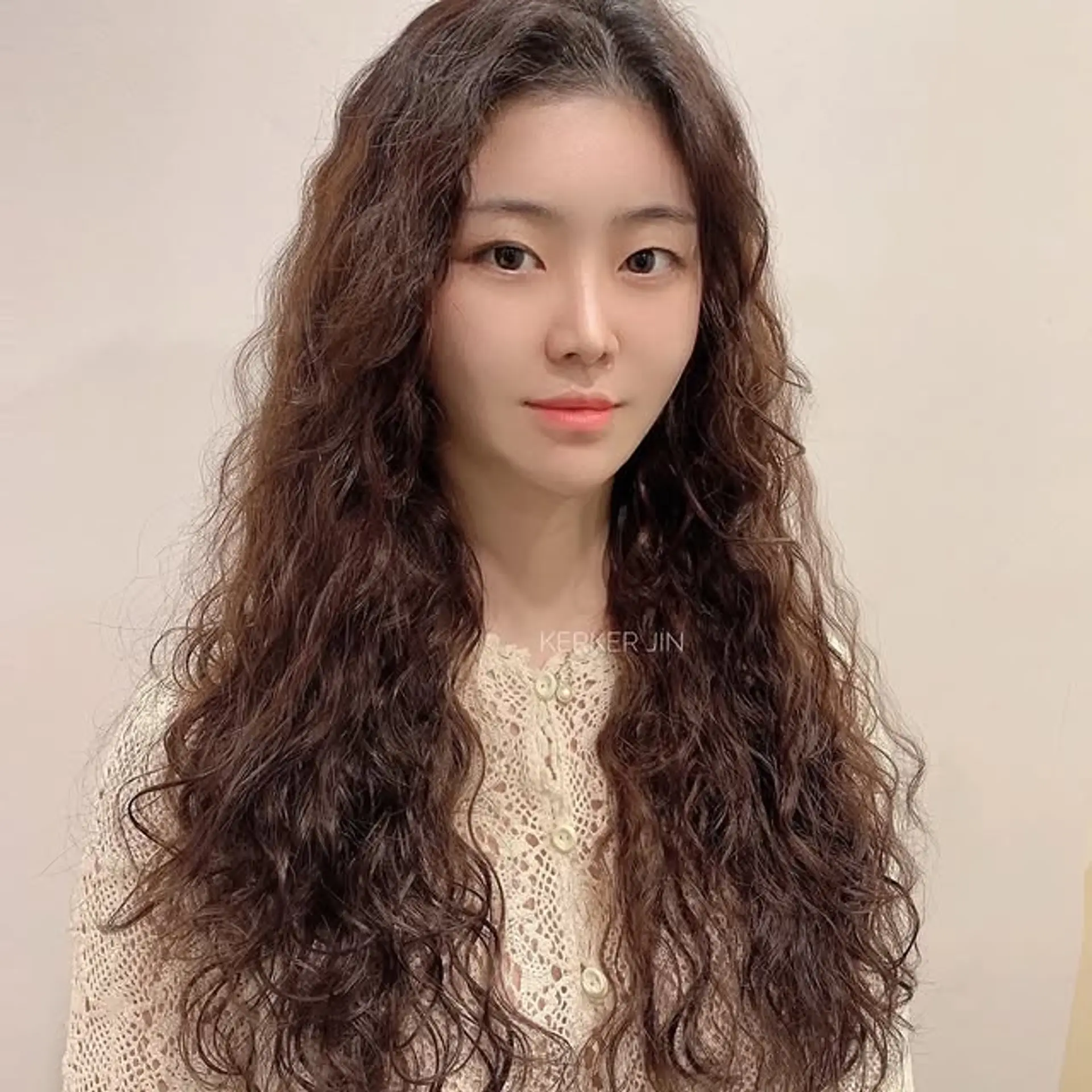 This is a long layered perm with soft, natural waves. 1