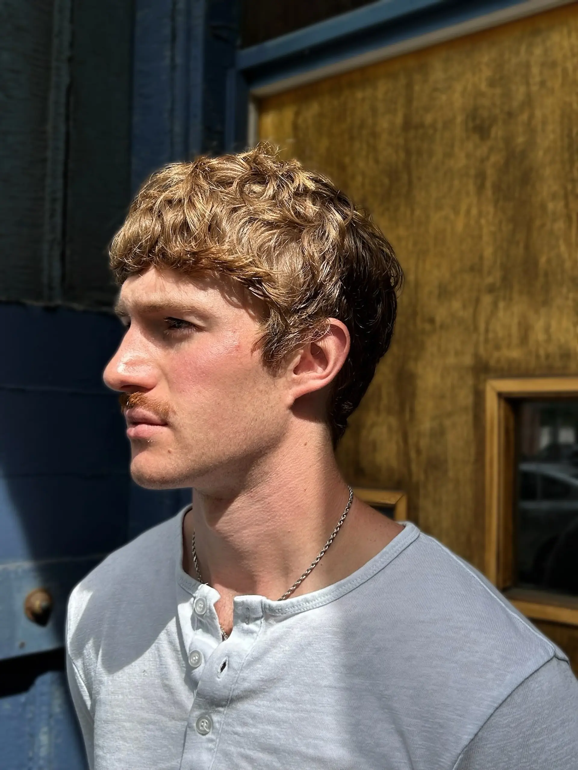 A textured short crop featuring natural wavy hair styled forward with a defined fringe and softly tapered sides. 1