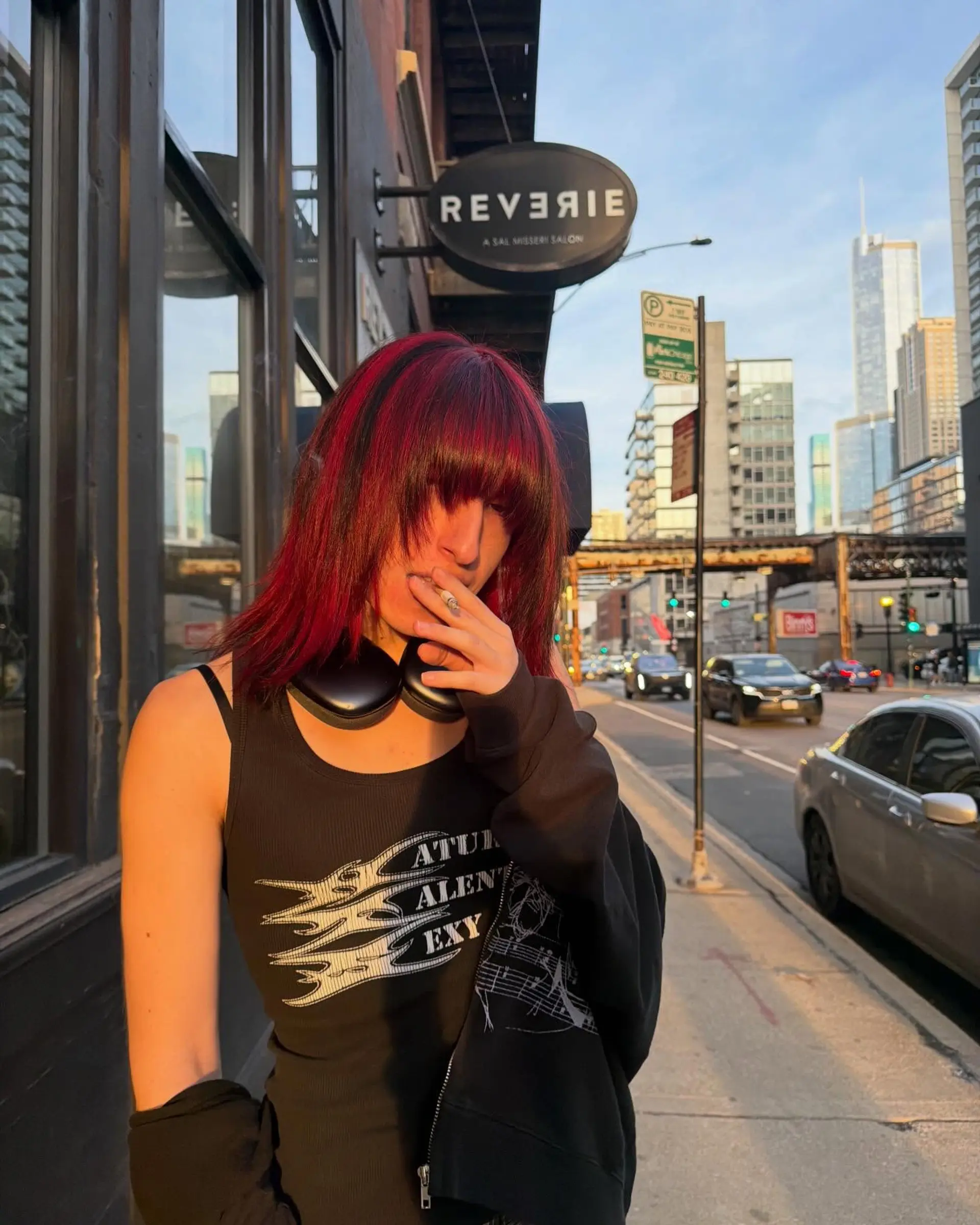 A medium textured shag featuring striking crimson red and black multi-tonal color with heavy, eye-grazing bangs. 1