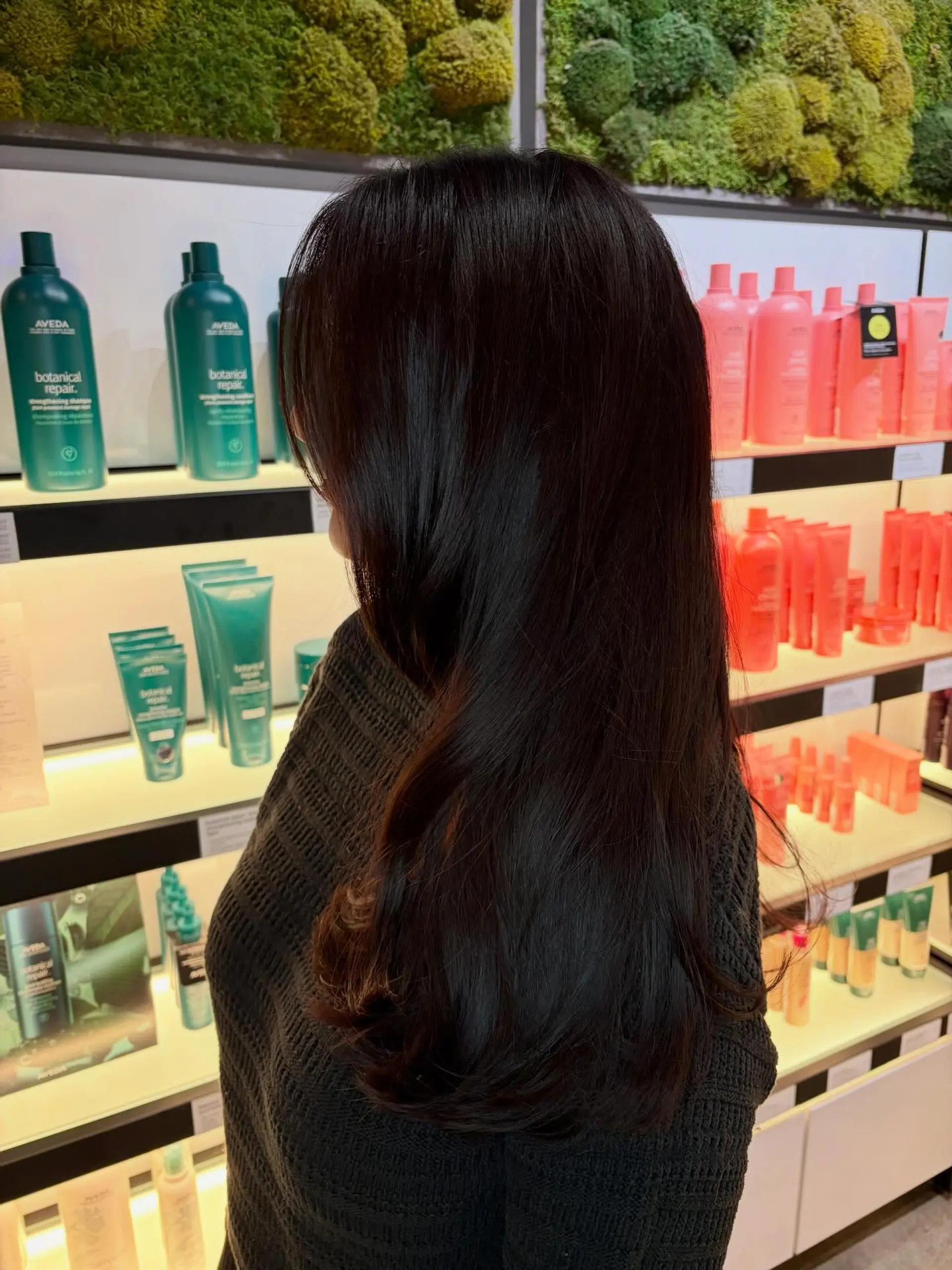 Long, rich dark brunette hair styled with a smooth, voluminous blowout and soft curls turned under at the ends. 1