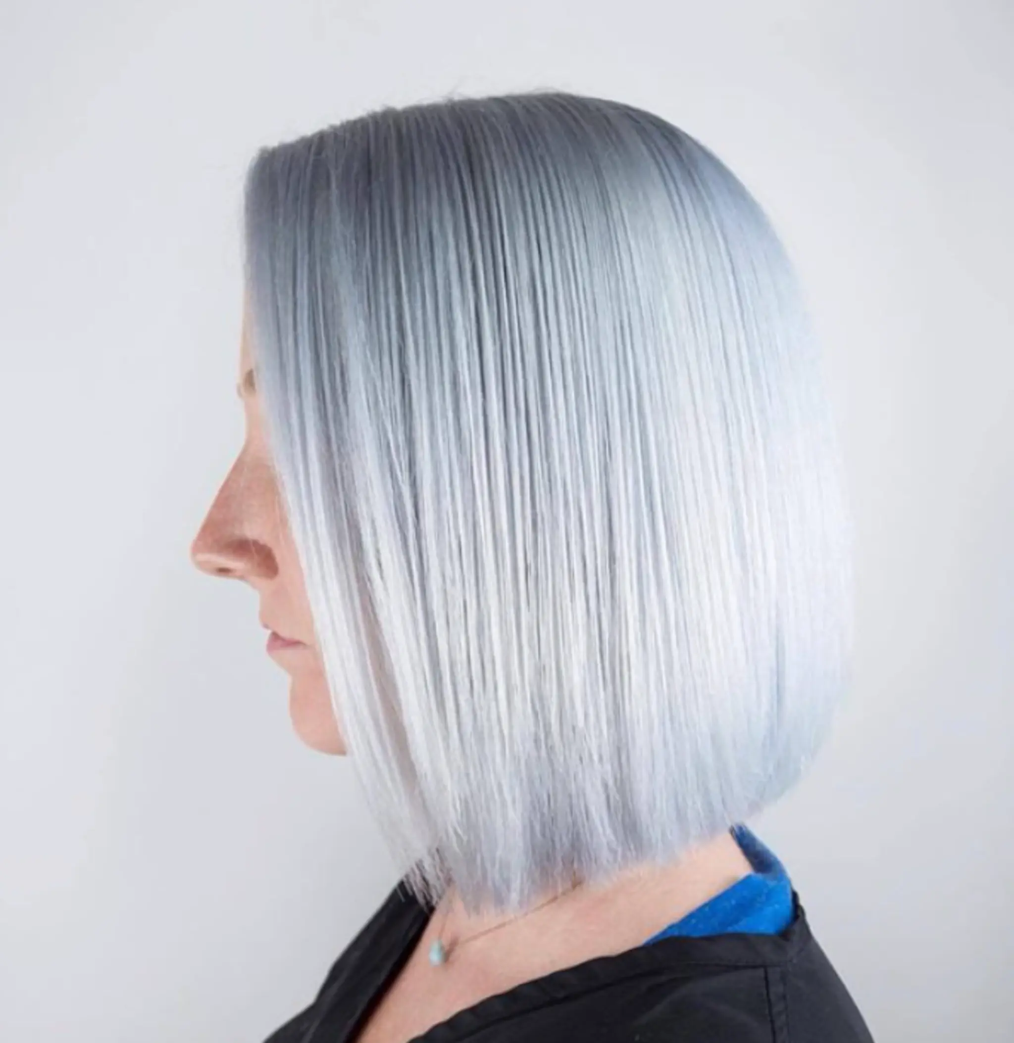 A sleek silver bob with a blunt cut. The hair is straight and smooth, falling just below the chin in a modern, precise style.