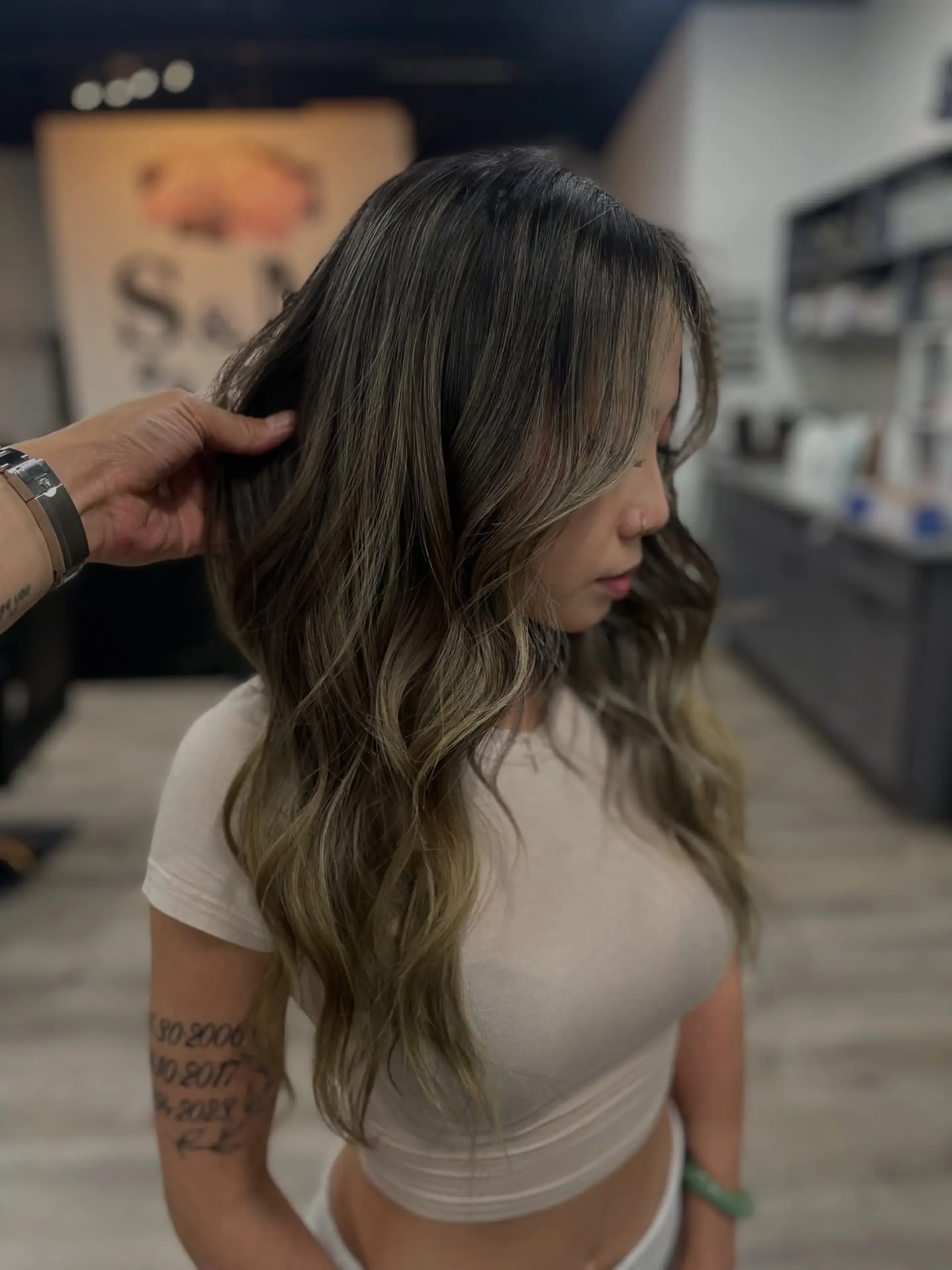 Medium length wavy hairstyle with an ash brown balayage. 1