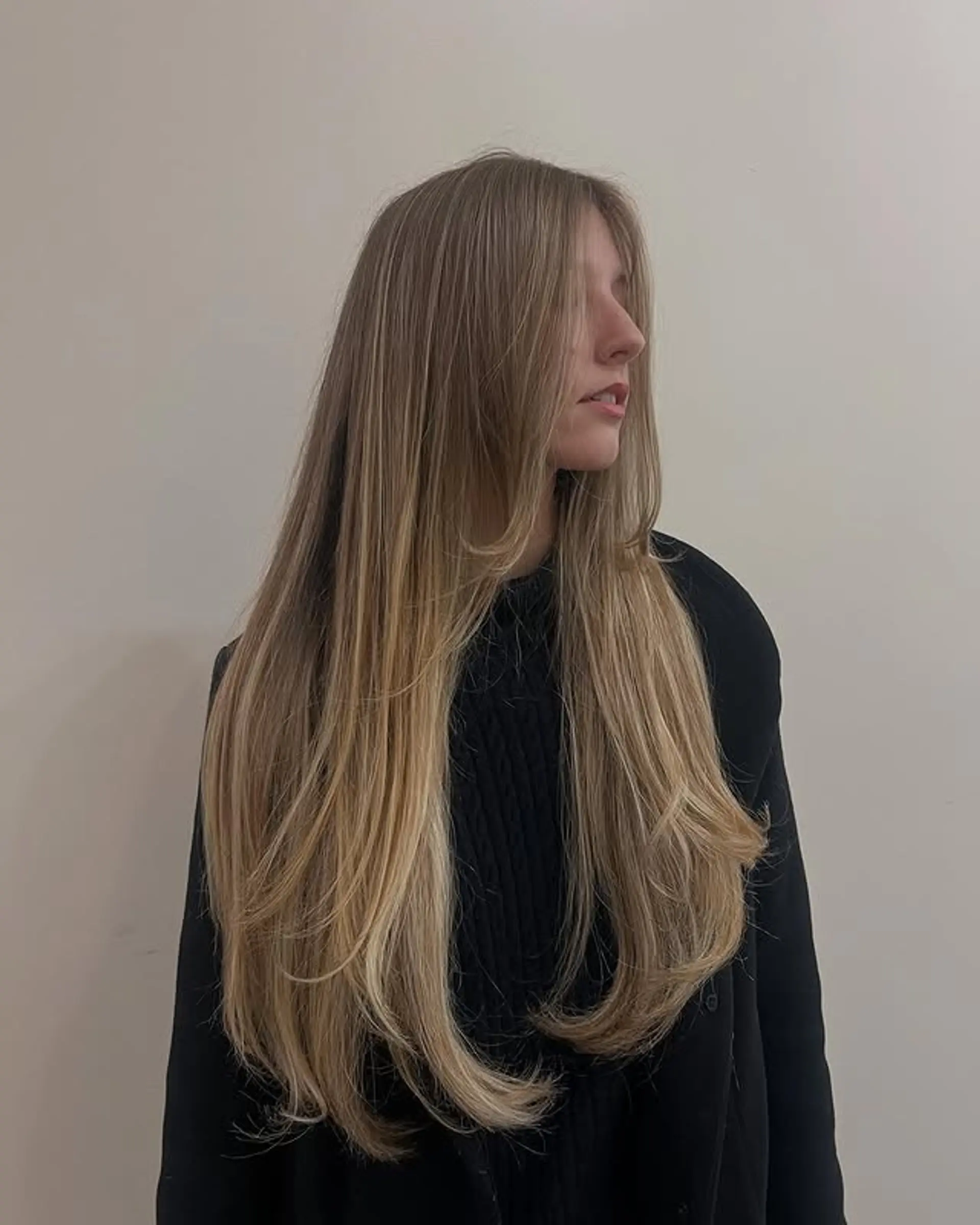 A very long layered haircut with face-framing layers. 1