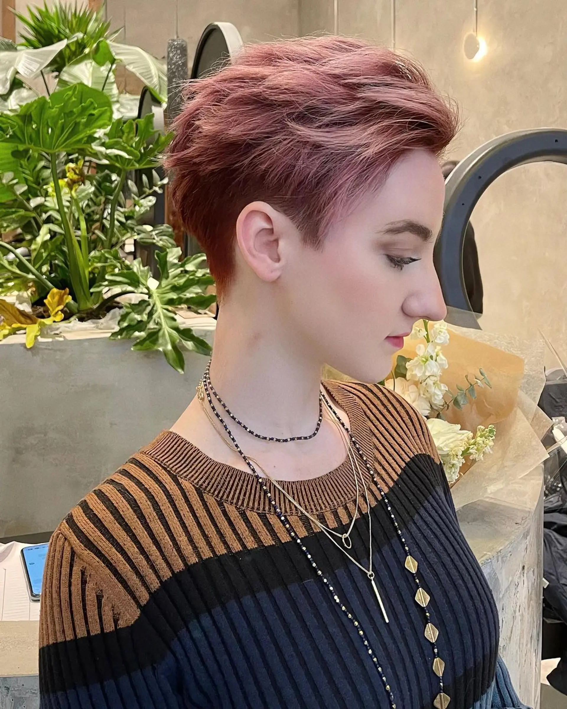 A short, wavy pixie with textured layers, highlighted by rose gold and pink tones. The sides and back are tapered, while the top is left slightly longer for added volume and movement. 🫘Hair by @kelvin_ly1011 🫘 1