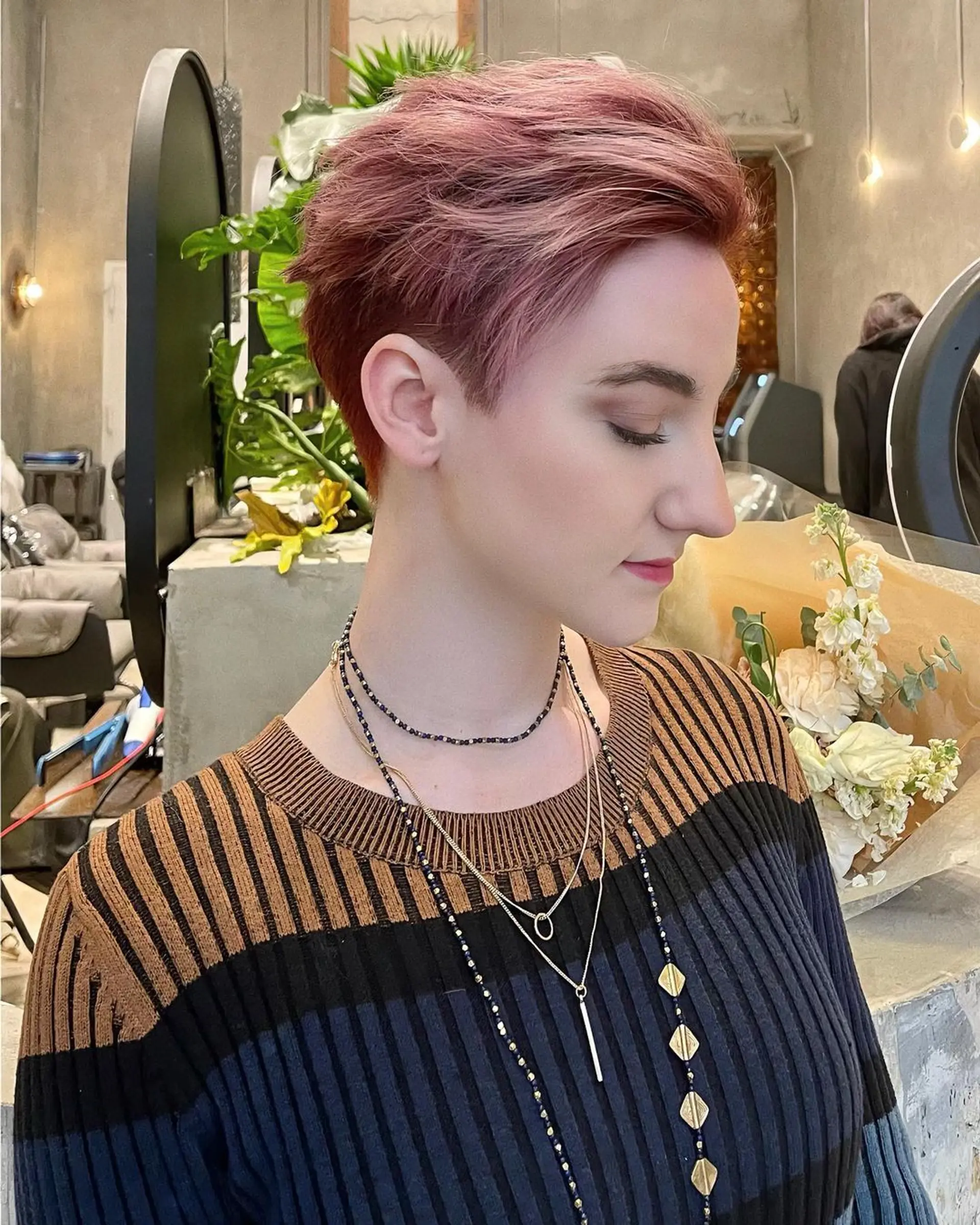 A short, wavy pixie with textured layers, highlighted by rose gold and pink tones. The sides and back are tapered, while the top is left slightly longer for added volume and movement. 🫘Hair by @kelvin_ly1011 🫘 2