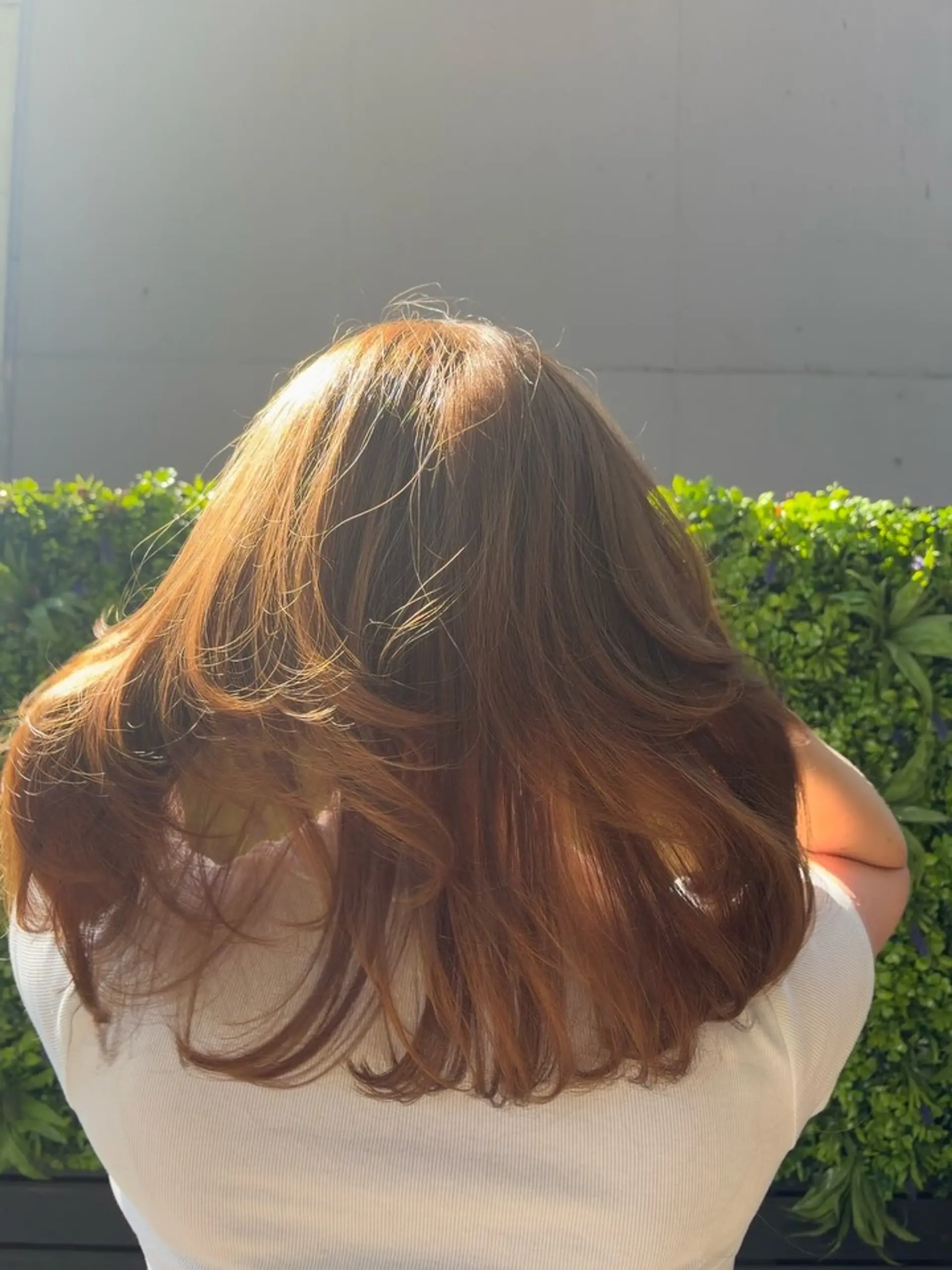 Medium-length warm brown hair cut into textured layers and styled with a voluminous, bouncy blowout. 1
