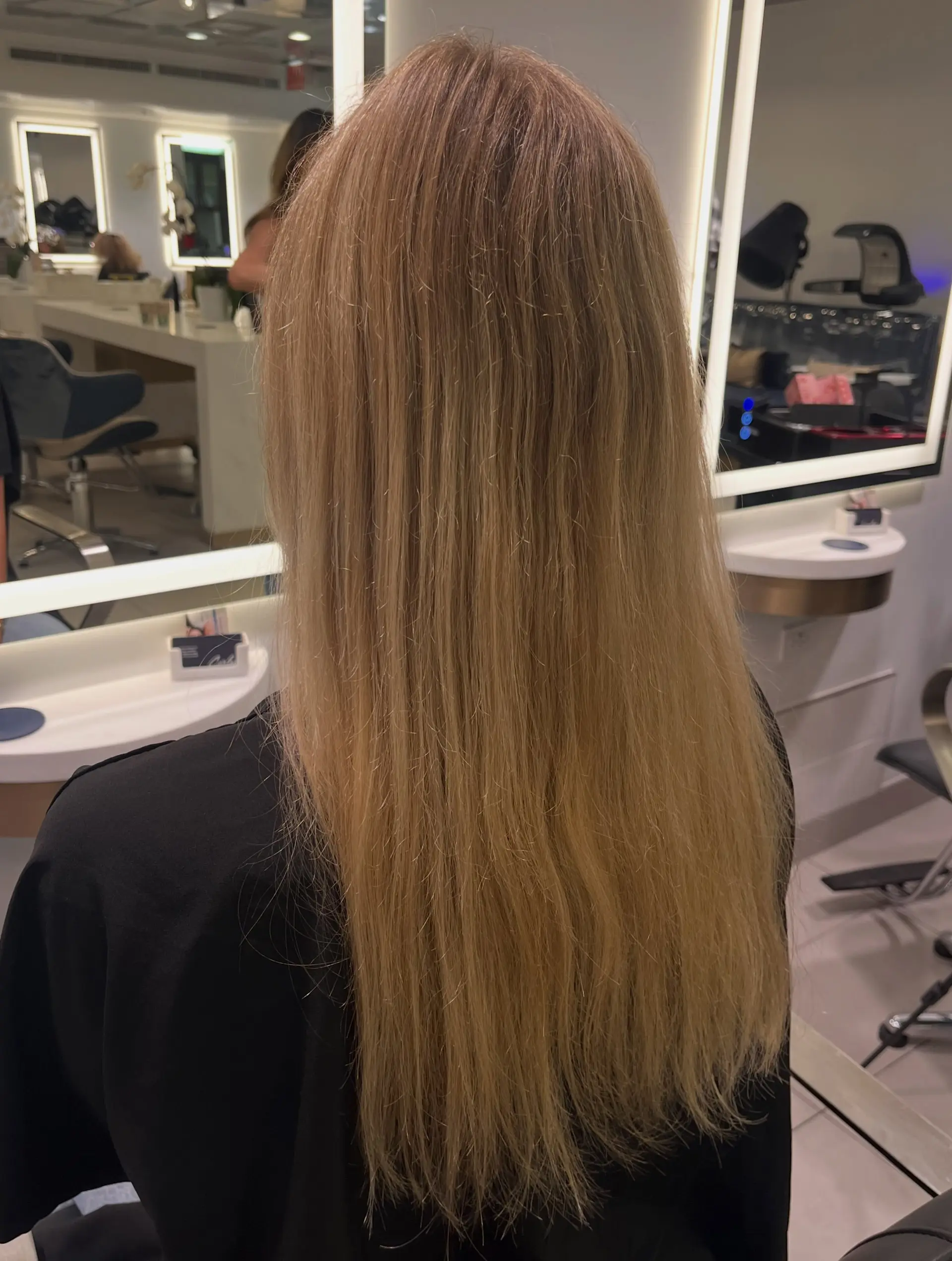 Long straight hair styled smooth, featuring a soft pastel pink tint over a warm blonde base. 1