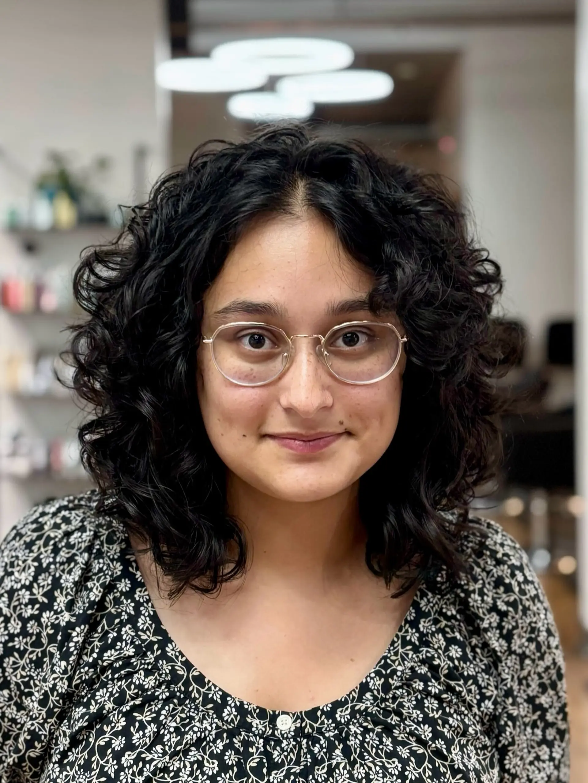 A mid-length shag haircut featuring natural curly hair. 1