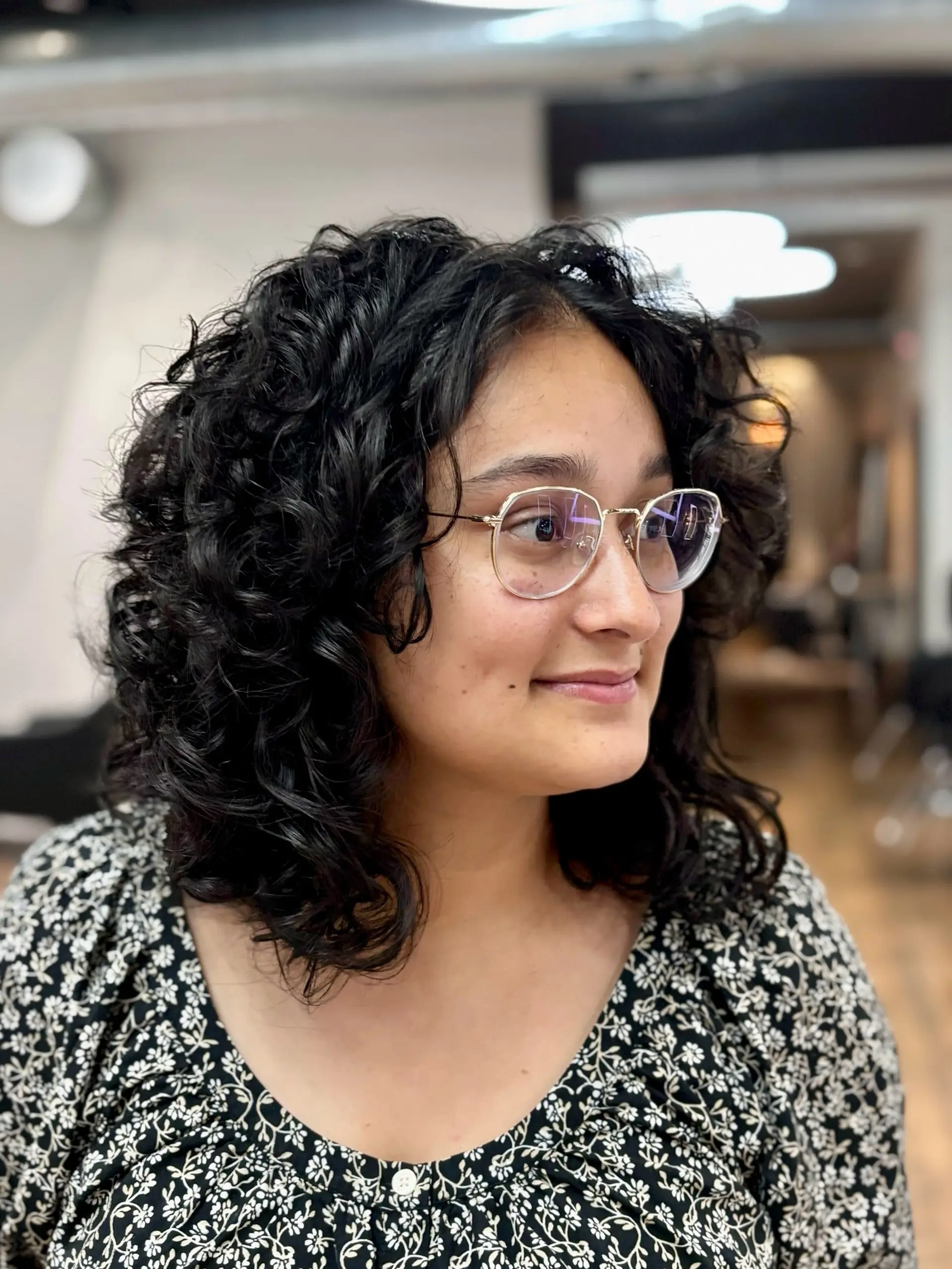 A mid-length shag haircut featuring natural curly hair. 2