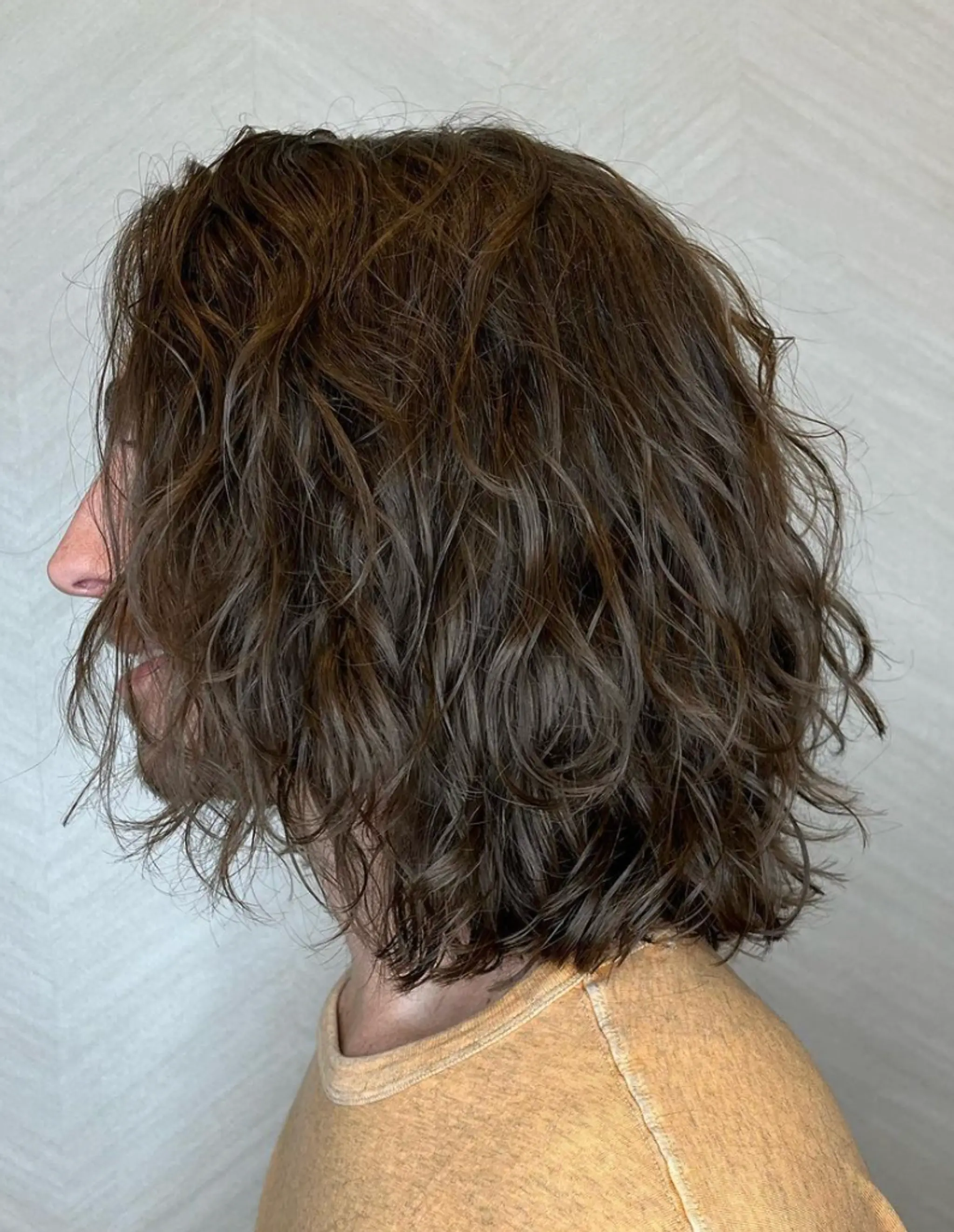 Medium-length, brown, wavy hair with a side part creating a casual and natural look.

Cut and style by @juliamannino_hair
 2