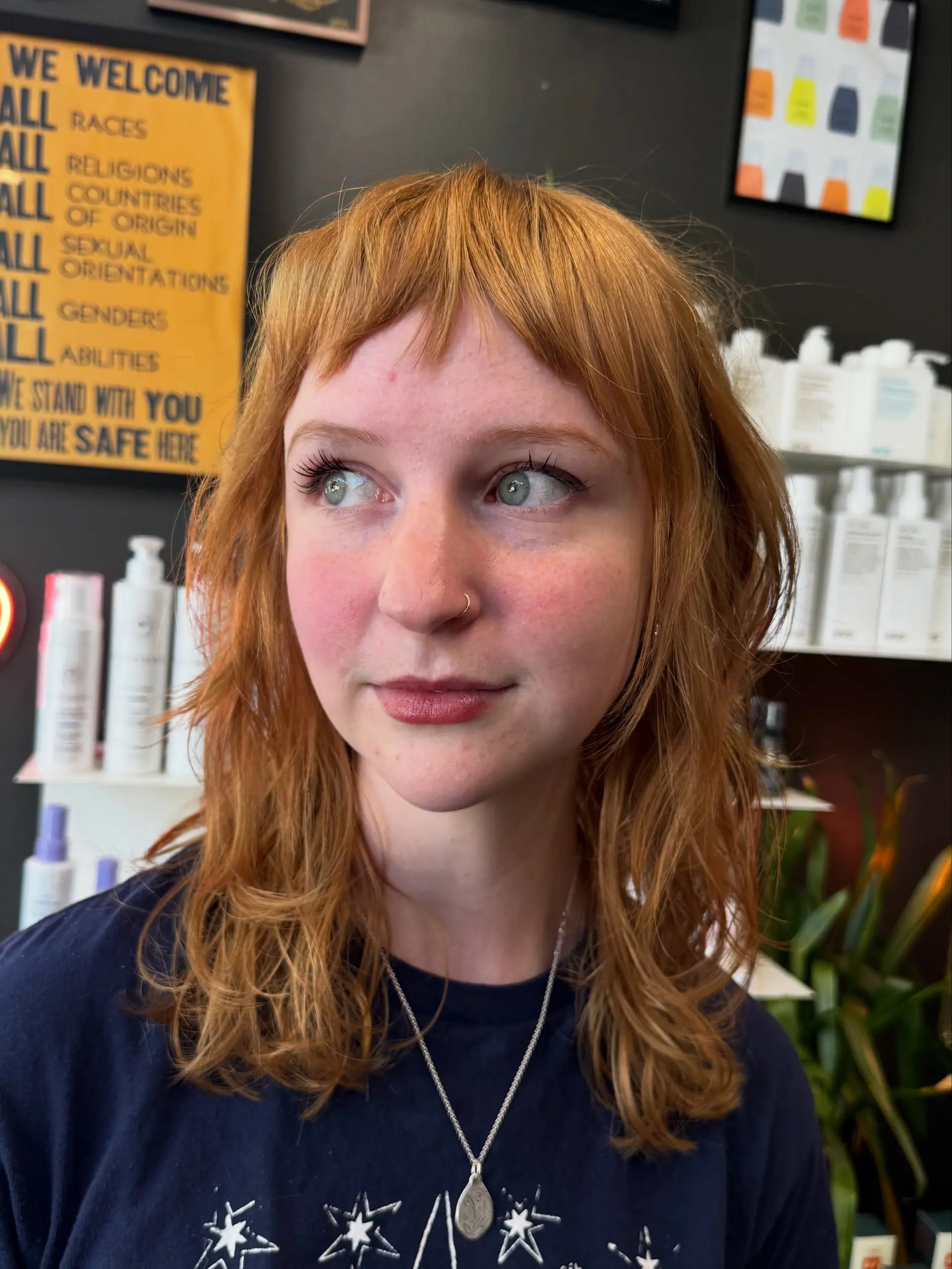 A mid-length textured shag featuring short, piecey baby bangs and softly layered natural waves. 1