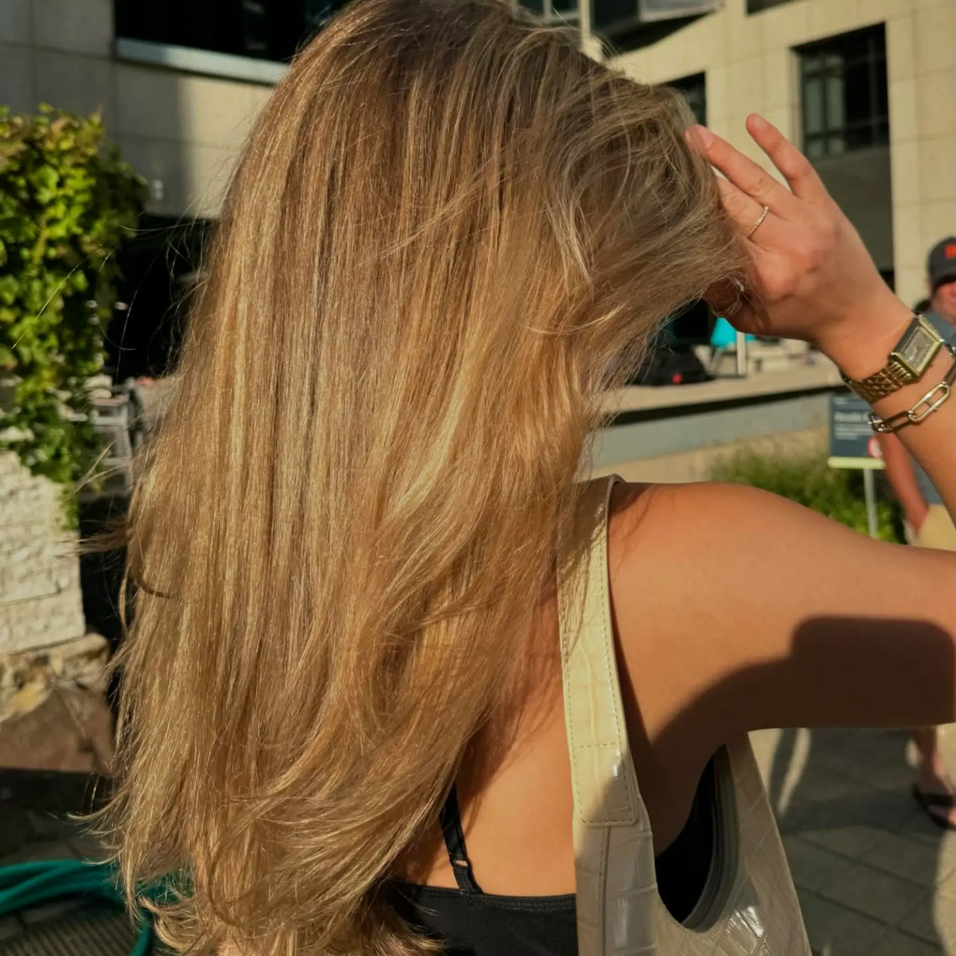 A long, layered cut with face-framing pieces and natural texture, styled with soft waves that add volume and movement throughout the hair. 3