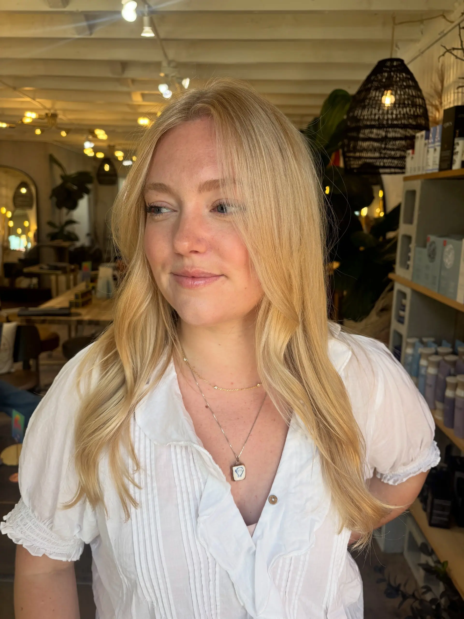 Long, warm dimensional blonde hair styled with a smooth blowout and subtle face-framing bends. 1