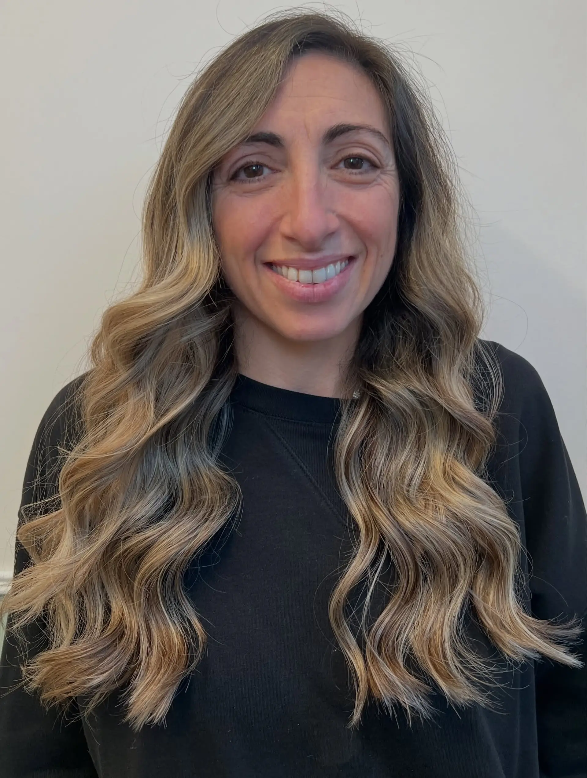 Long flowing waves styled with seamless dimensional blonde balayage highlights. 1