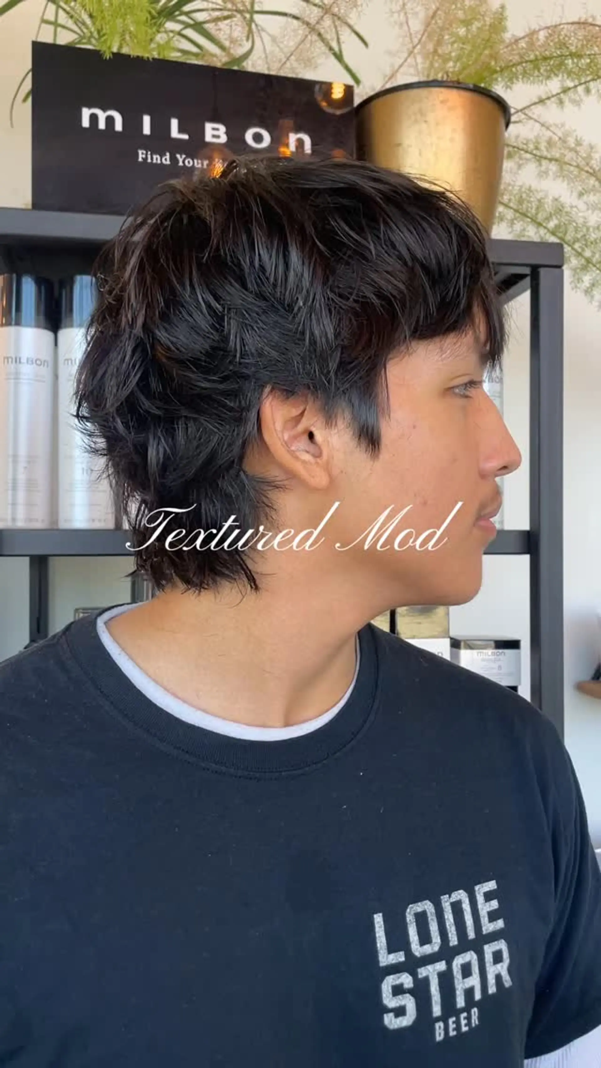 A layered, textured mod haircut in natural dark hair featuring piecey fringe and length around the ears and nape. 1