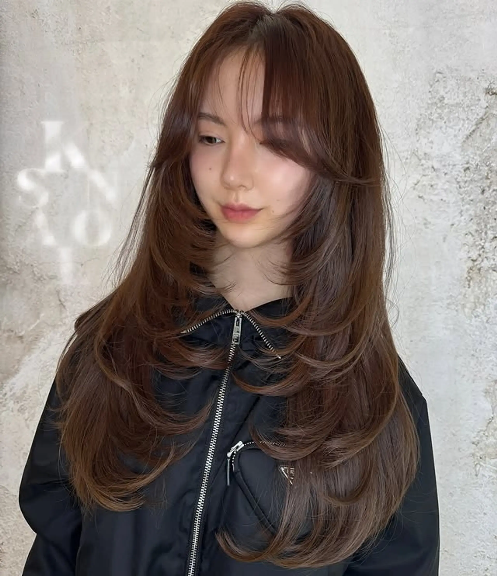 A long layered butterfly haircut with see-through bangs. 1