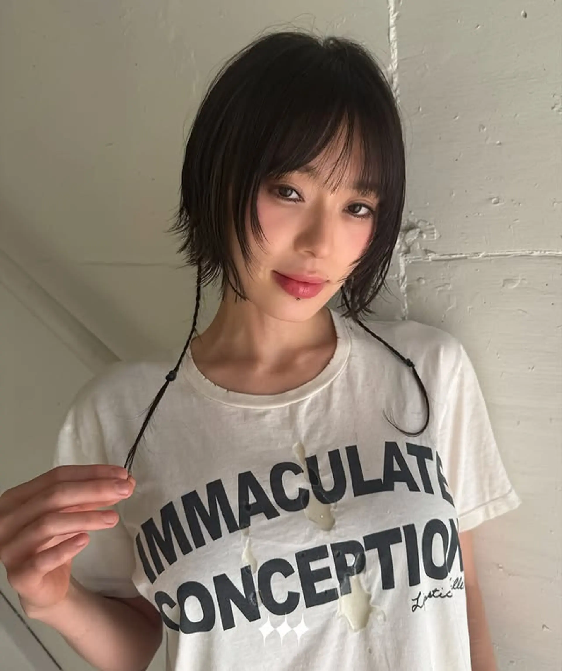 A shaggy bob with choppy layers and full bangs. 1