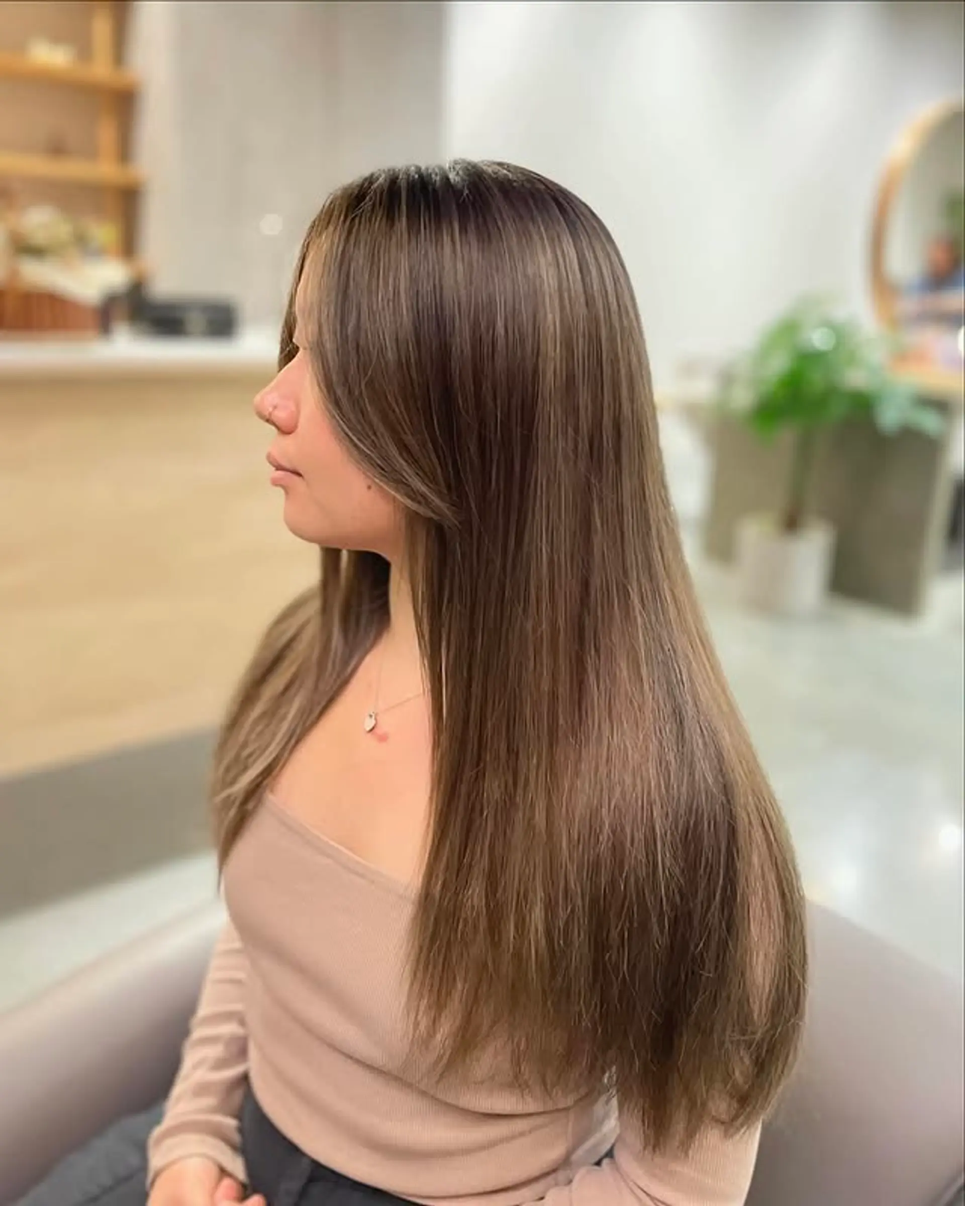 Long, layered hair with curtain bangs. 1