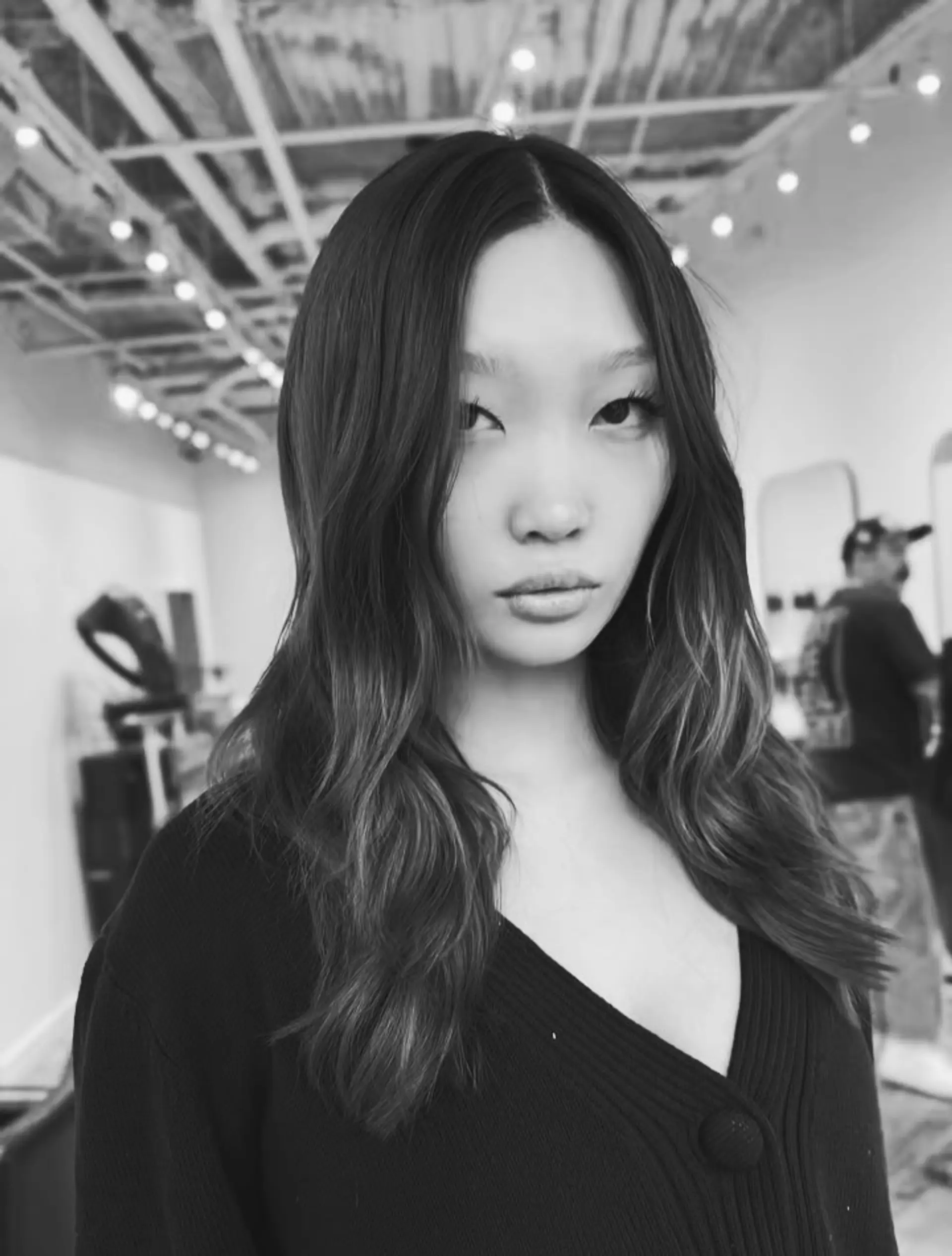 Long wavy hair with a center part and smooth color transition from dark roots to lighter ends. 1