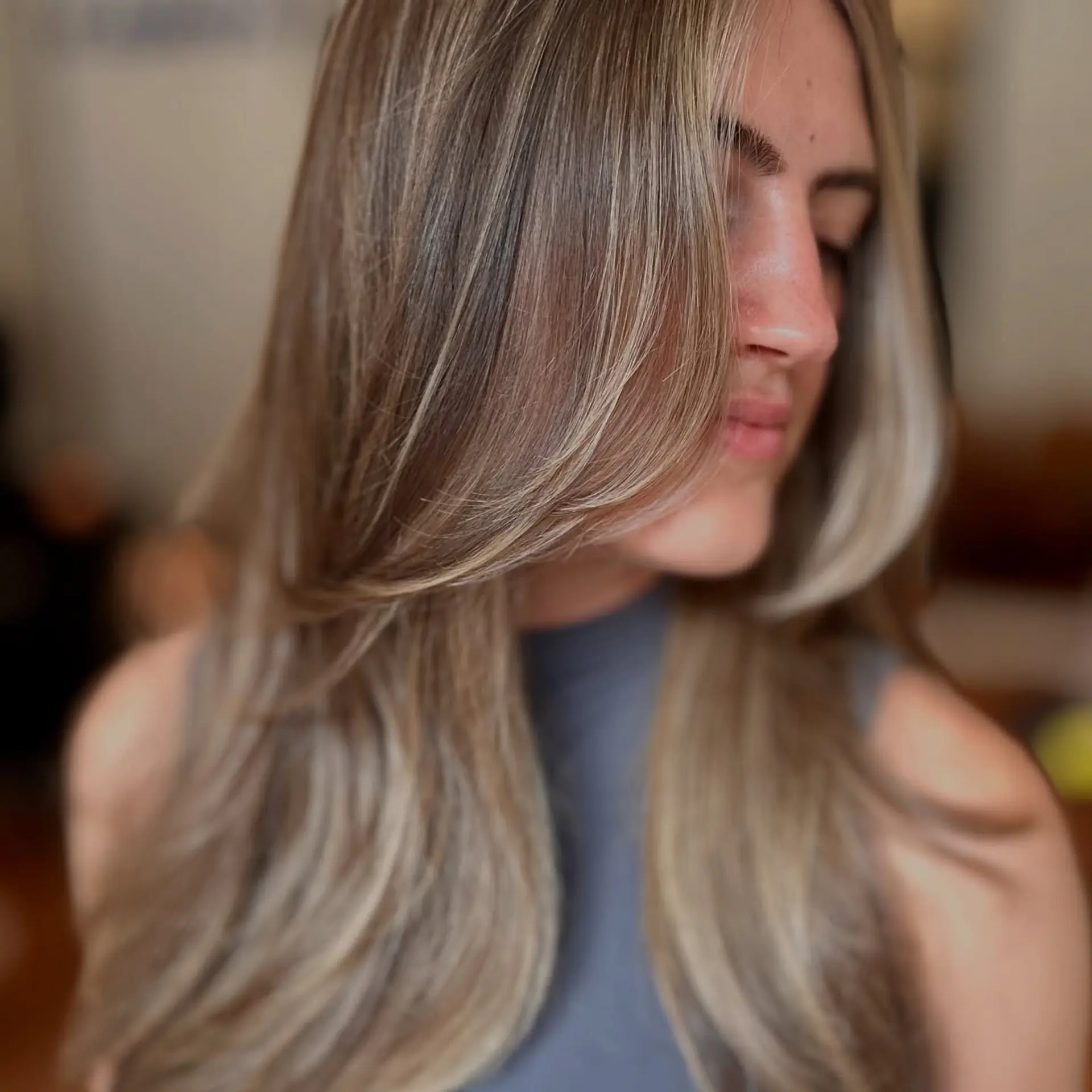 Long creamy blonde hair with seamless highlights and soft face-framing layers. 1