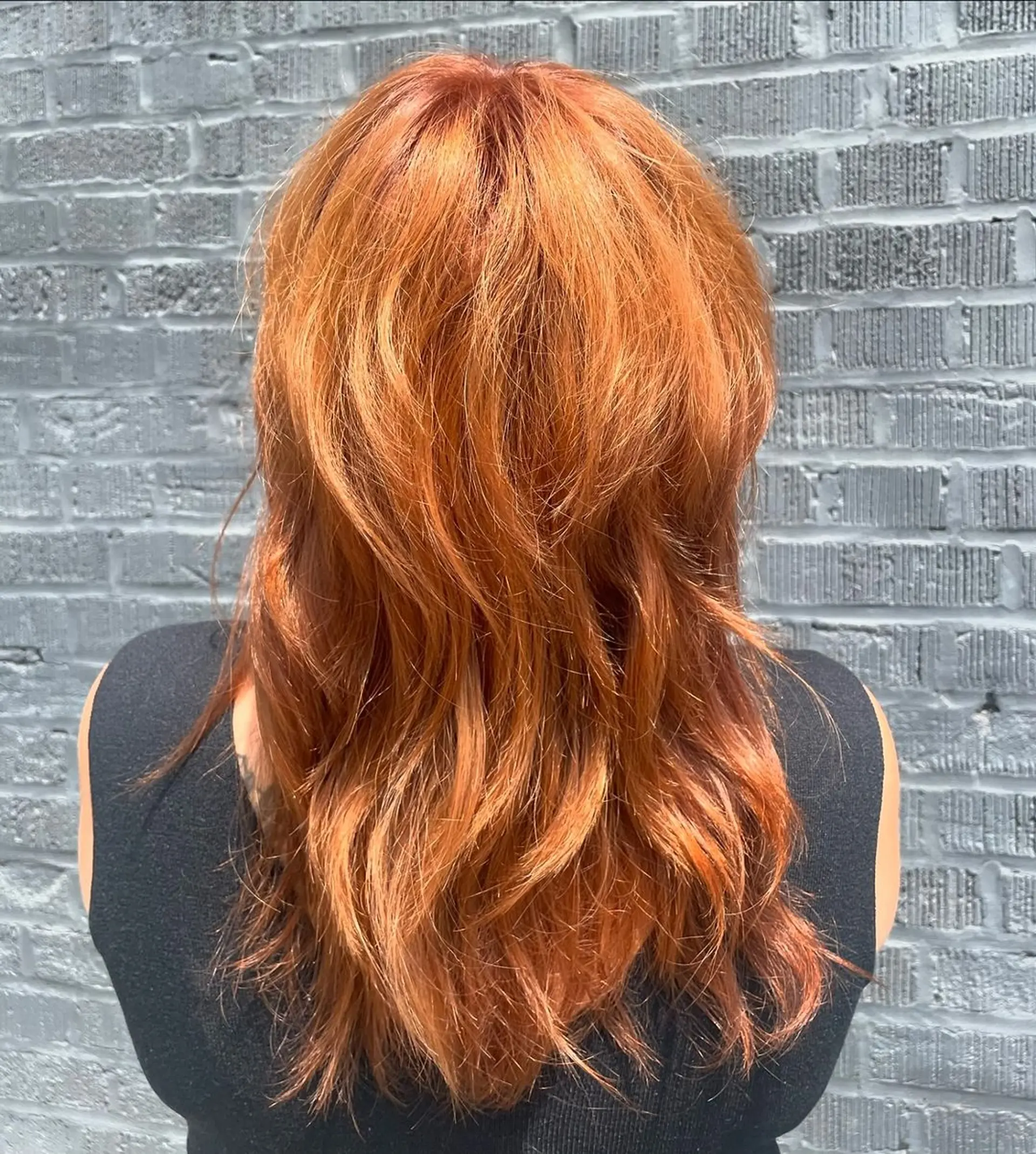 Medium-length cut with soft waves and a textured fringe, featuring a vibrant copper color. 2