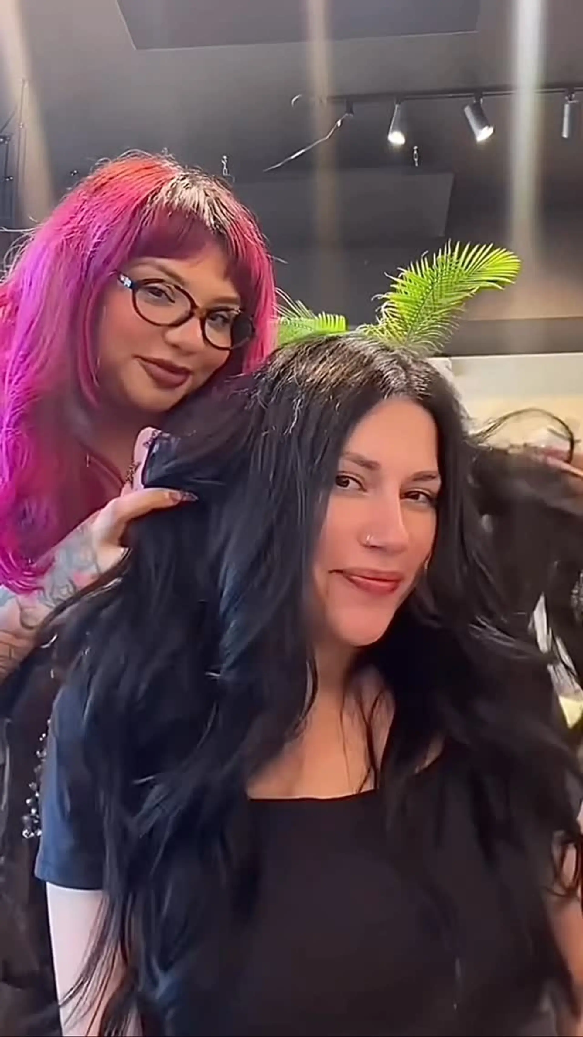Long, voluminous jet black hair styled into soft, flowing waves with high shine and a center part. 1