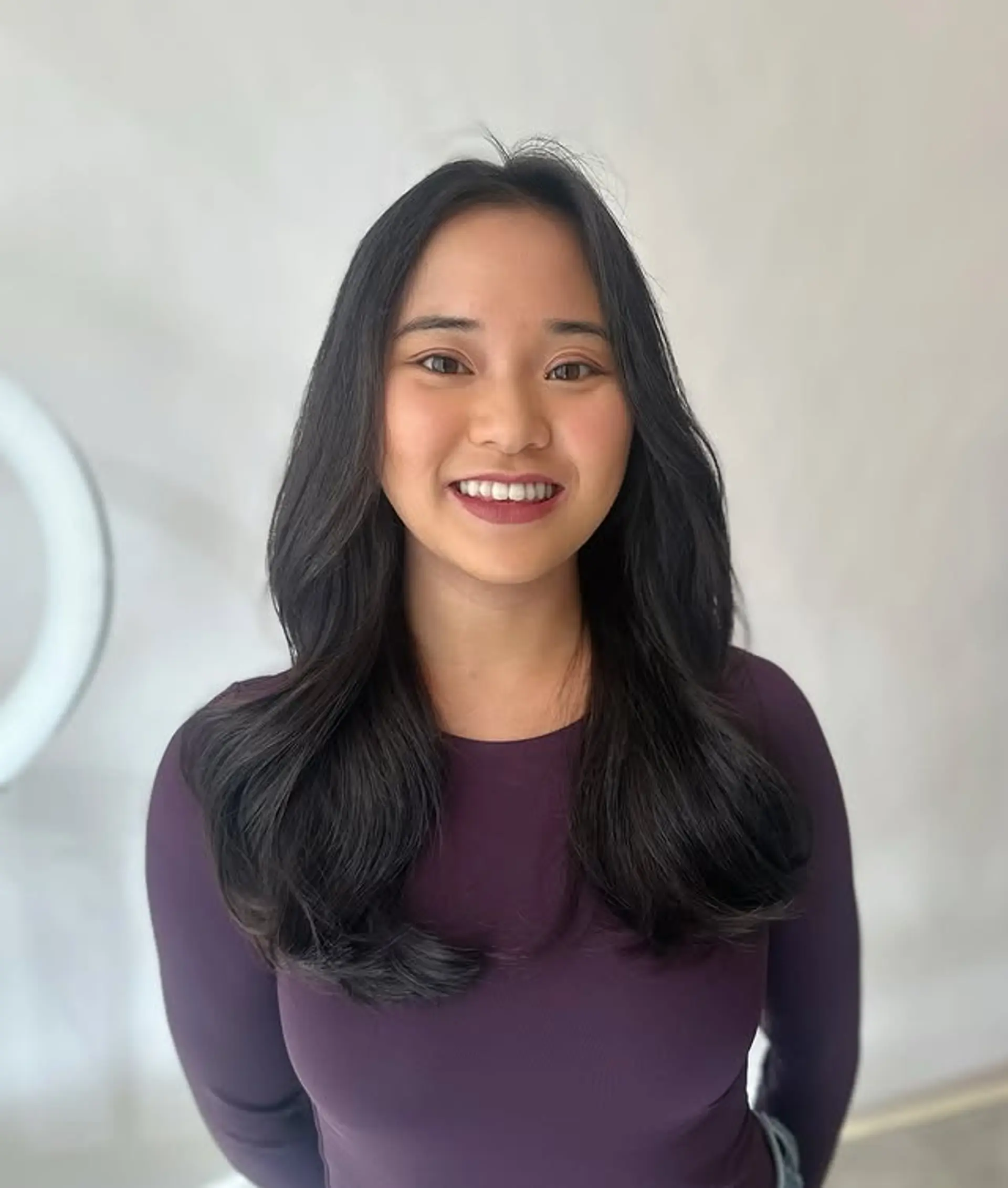 This hairstyle features curtain bangs with soft face-framing layers. 1