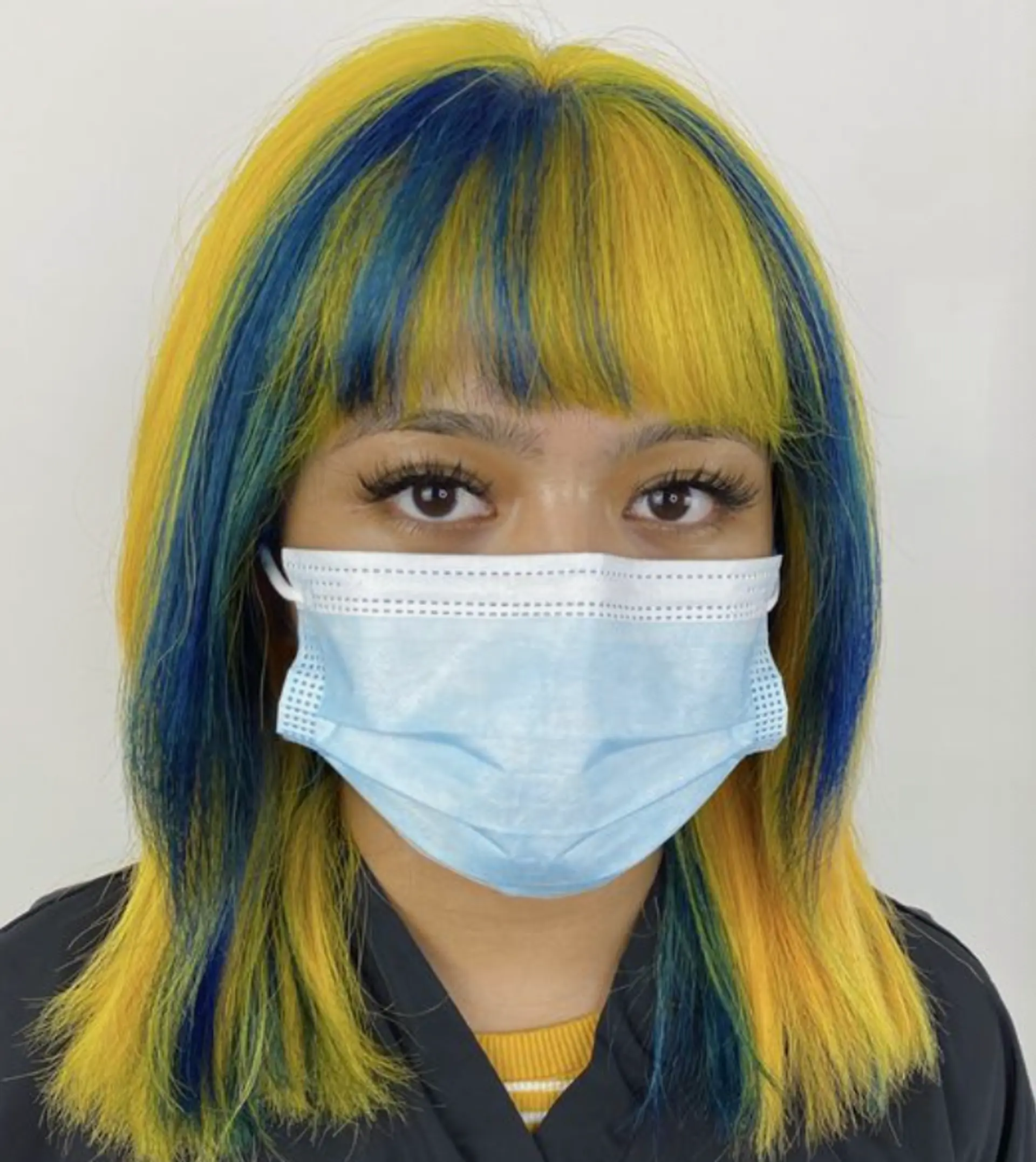 Straight, medium-length hair with a bold blend of yellow, blue, and green colors. Features a thick, blunt fringe and layered around the face for volume and texture. 1