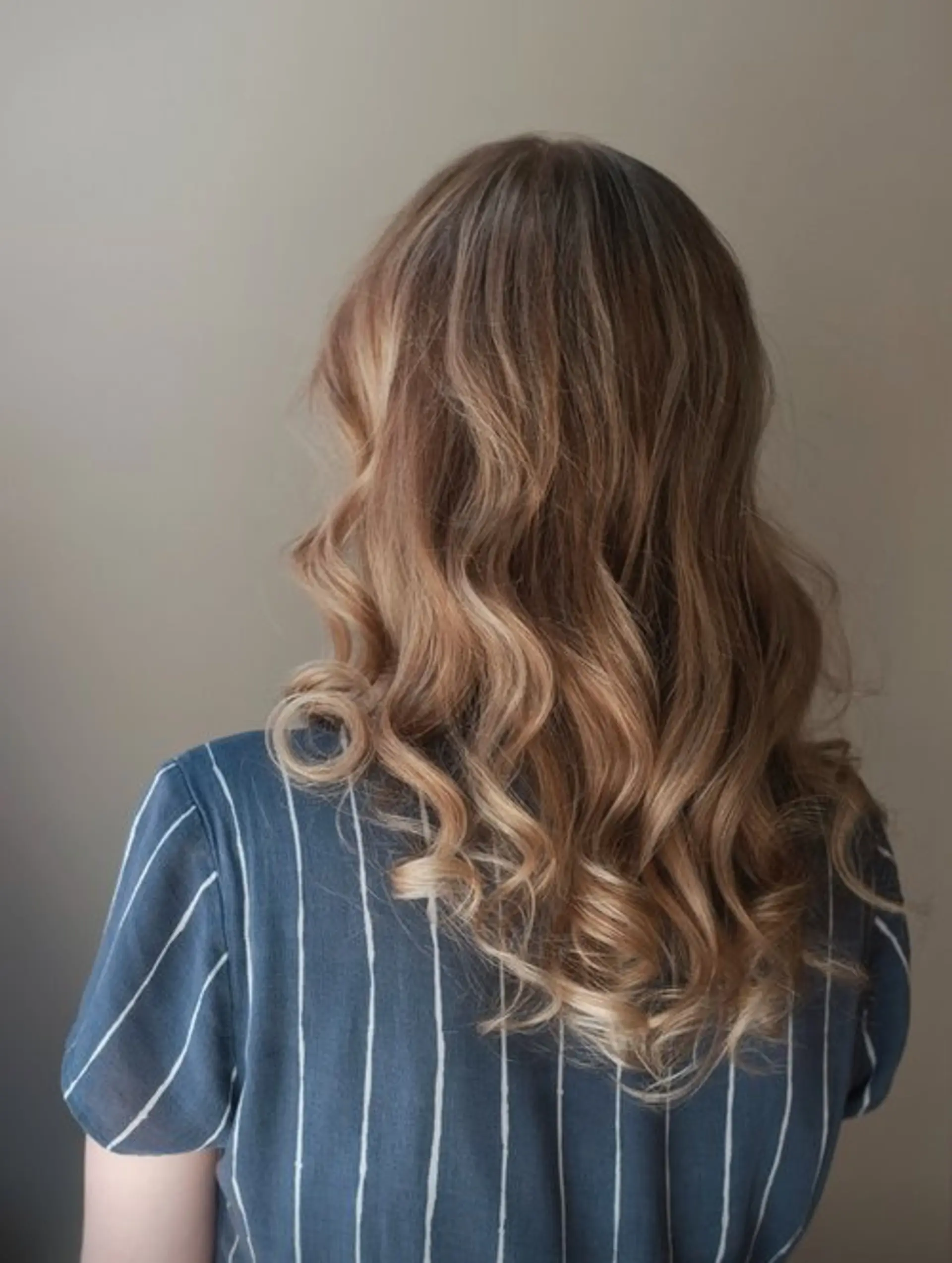 Medium length layered hair with a bronde balayage and curled ends. 1