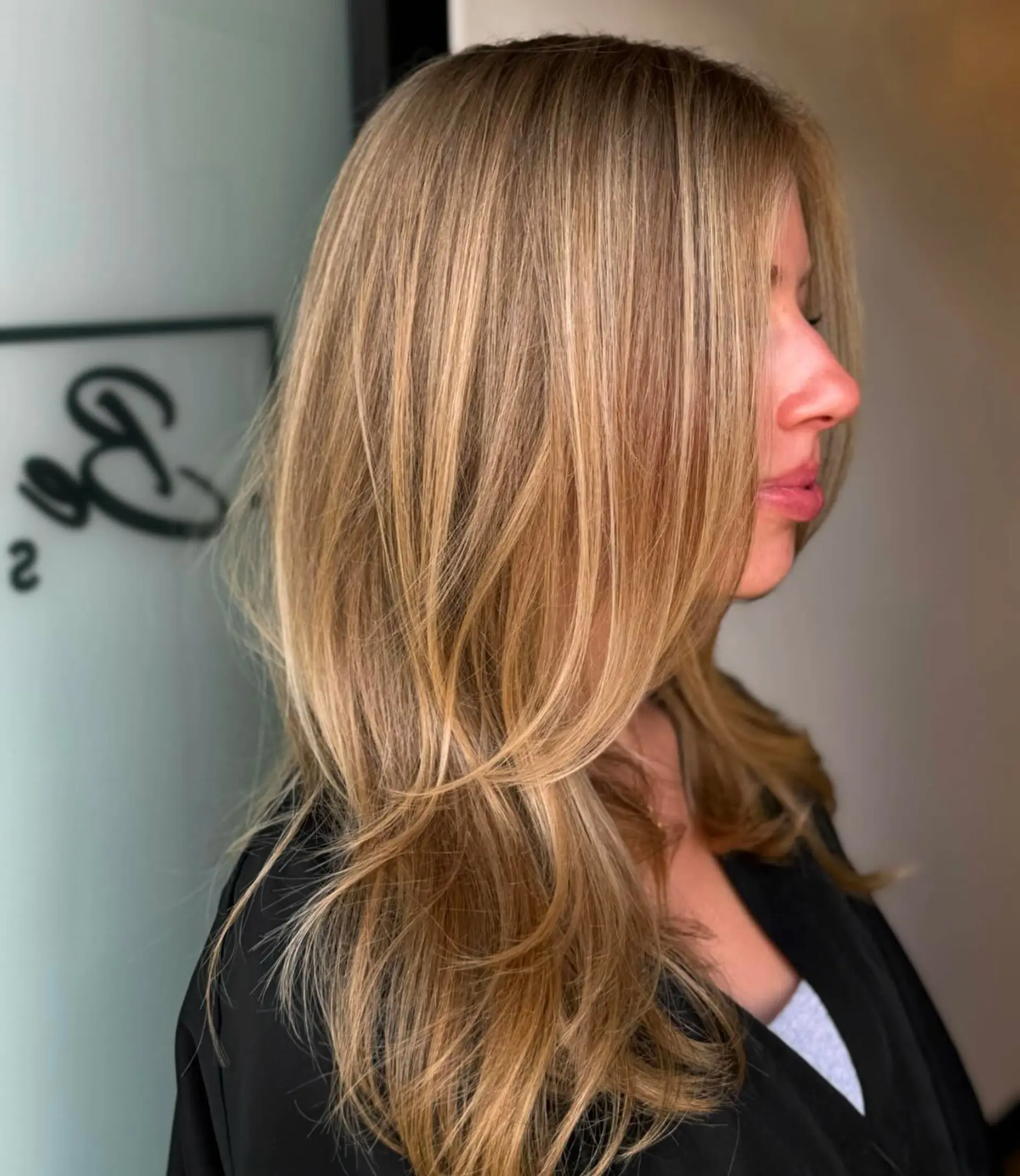 A warm buttery blonde balayage with multi-dimensional highlights and face-framing layers. 1