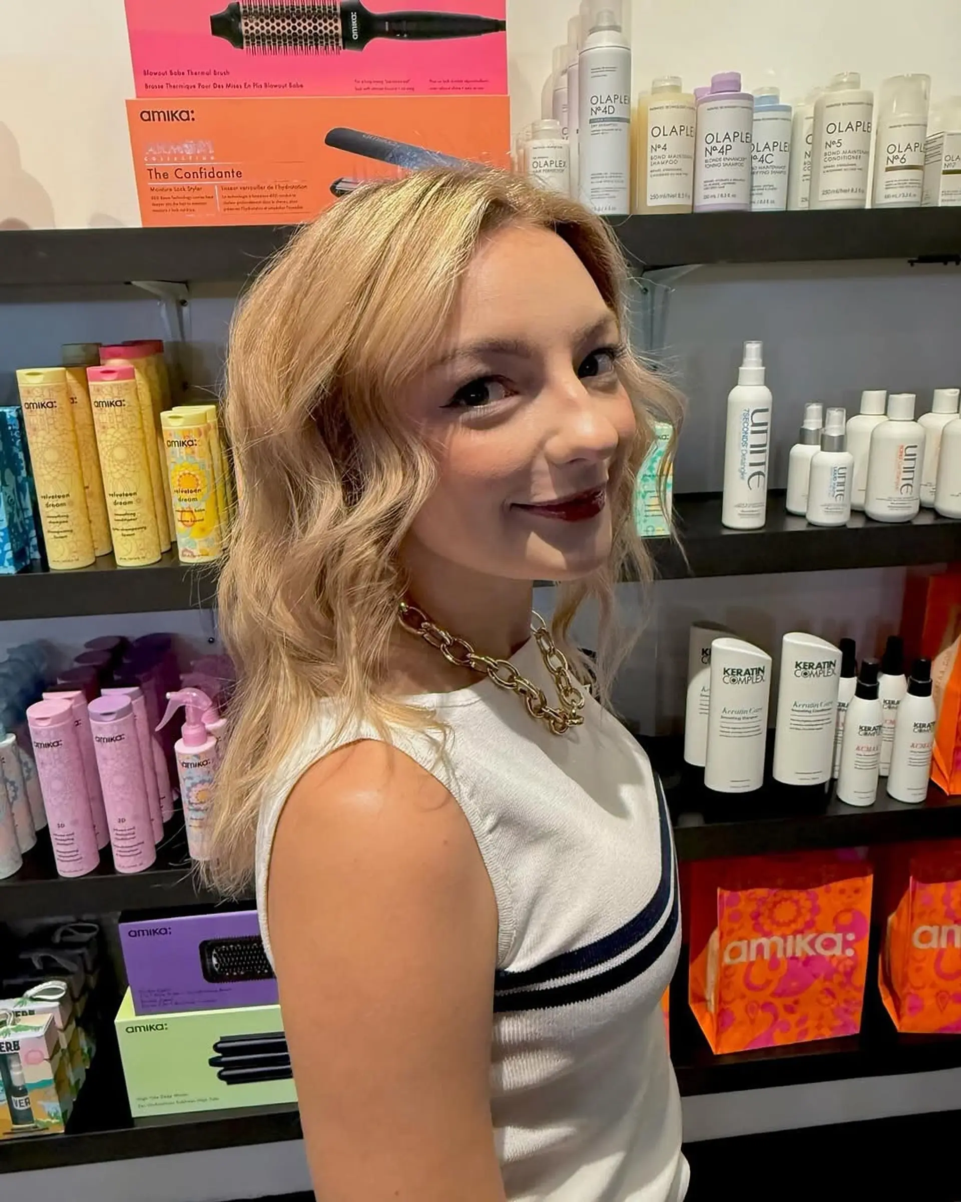 Medium-length warm golden blonde hair styled in soft, effortless waves. 1