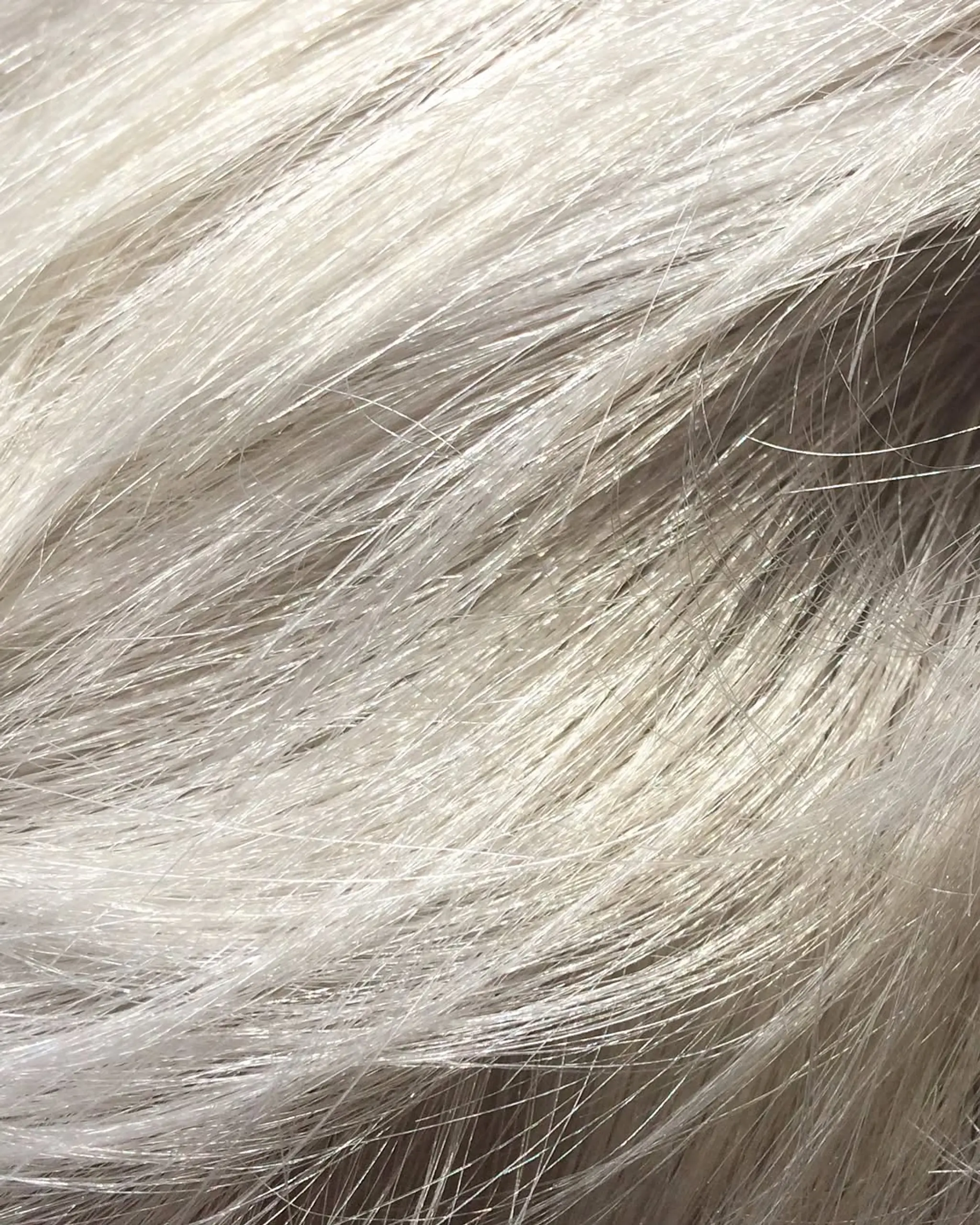 A sleek and straight medium-length hairstyle in an icy white shade. 1