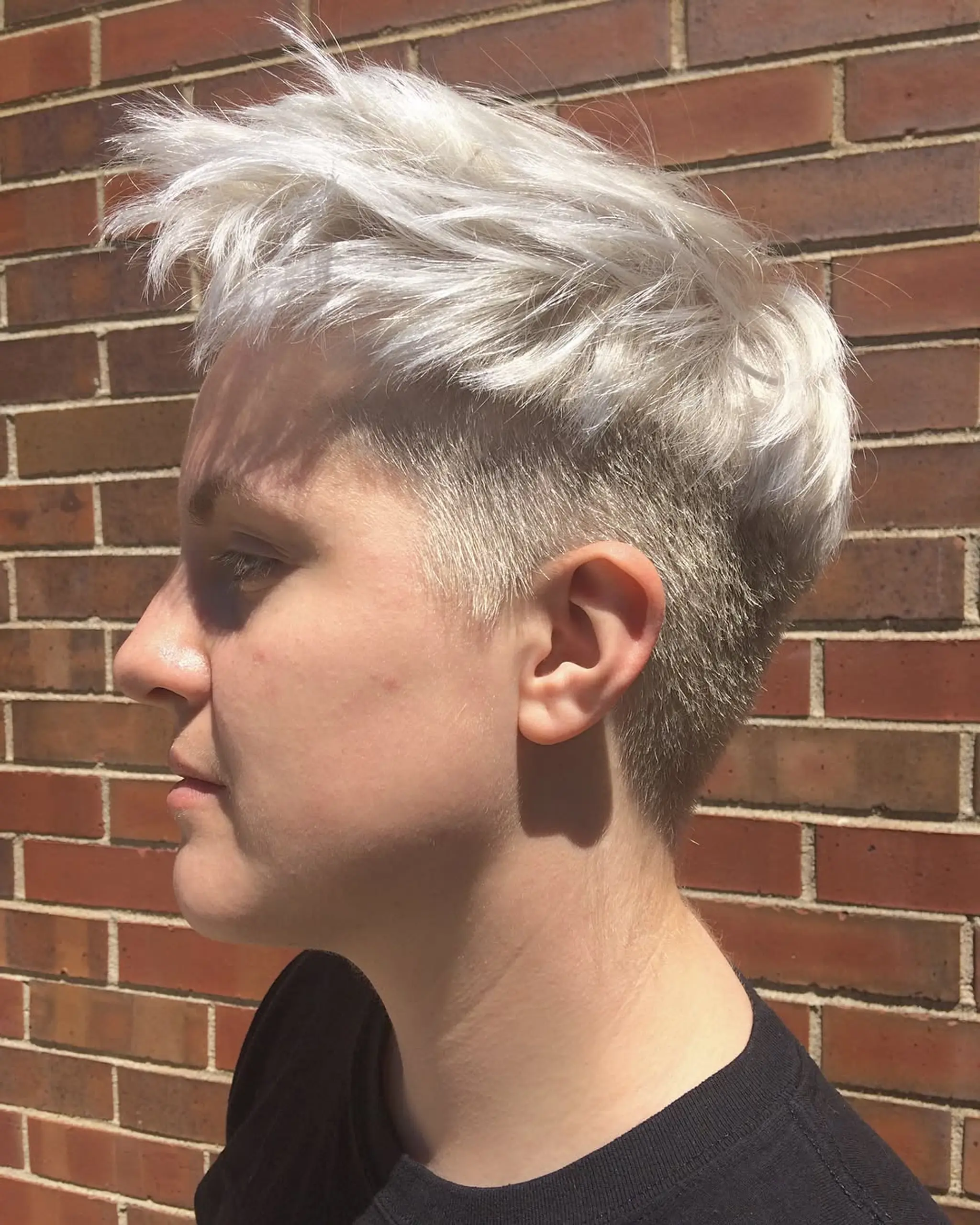 A sleek and straight medium-length hairstyle in an icy white shade. 2