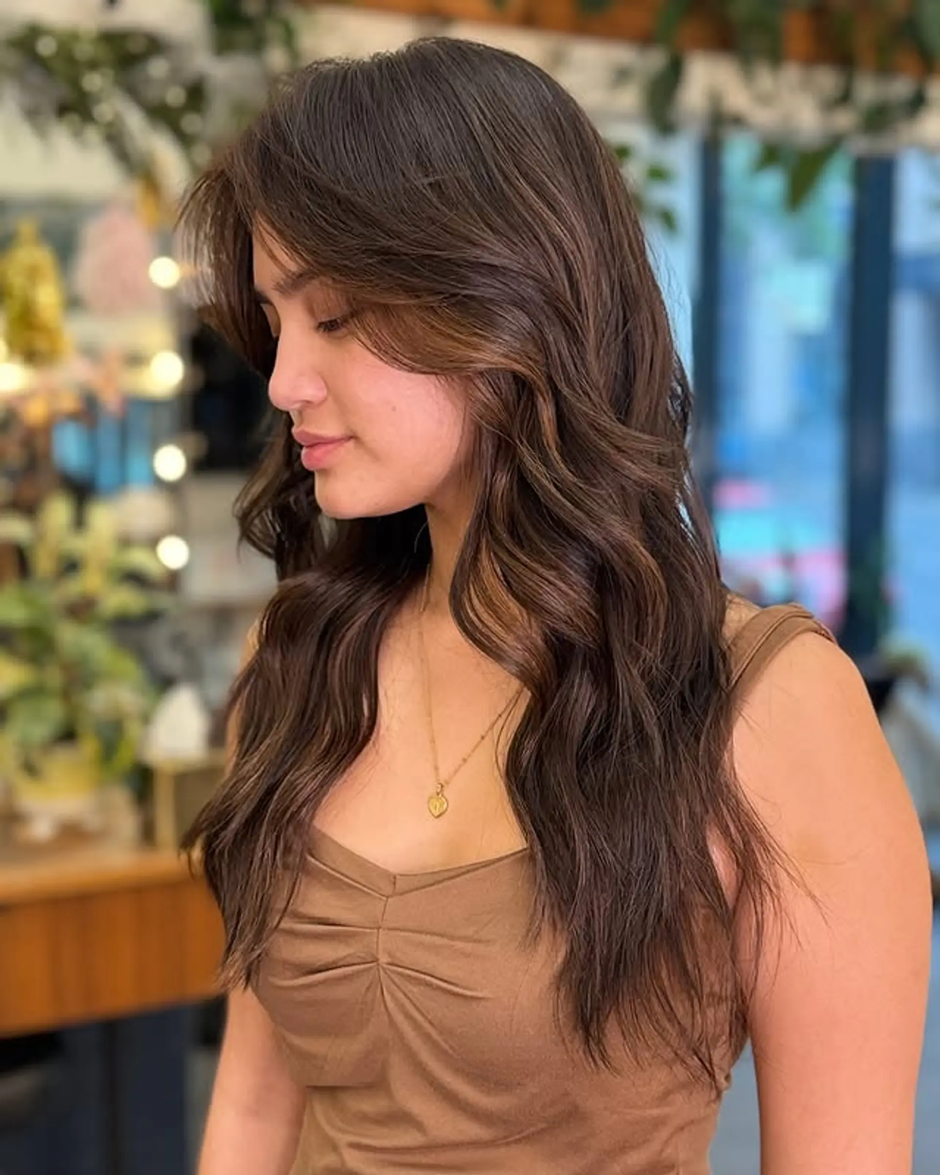 Long, layered wavy brunette with face-framing highlights. 1