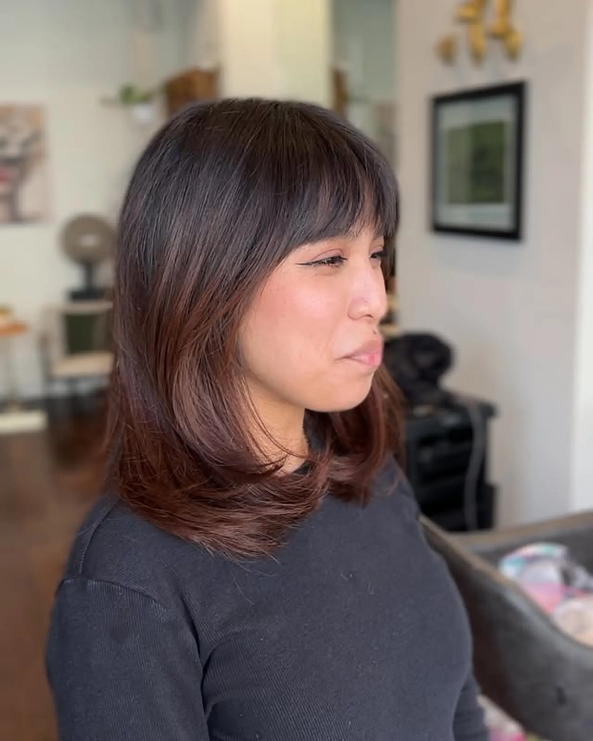 A chic shag haircut featuring face-framing layers and stylish curtain bangs. 1