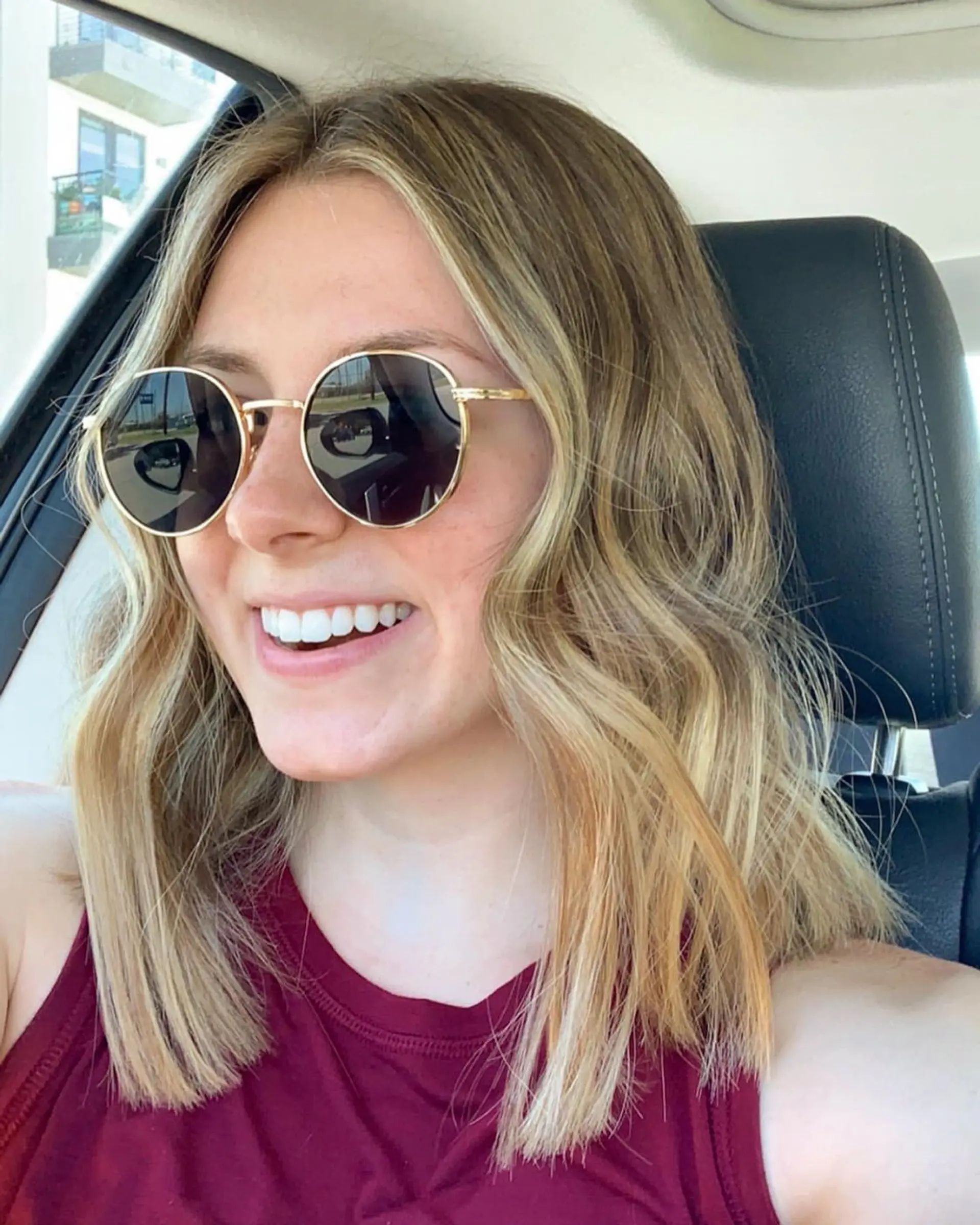 Collarbone-grazing lob featuring dimensional sun-kissed blonde highlights and effortless beach waves. 1