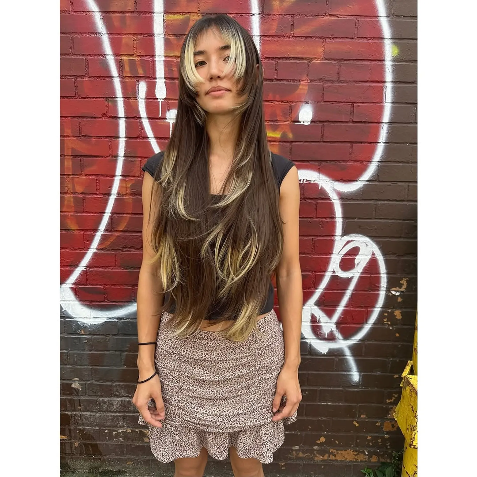 Long layered wolf cut with bold face-framing highlights and bangs. 1