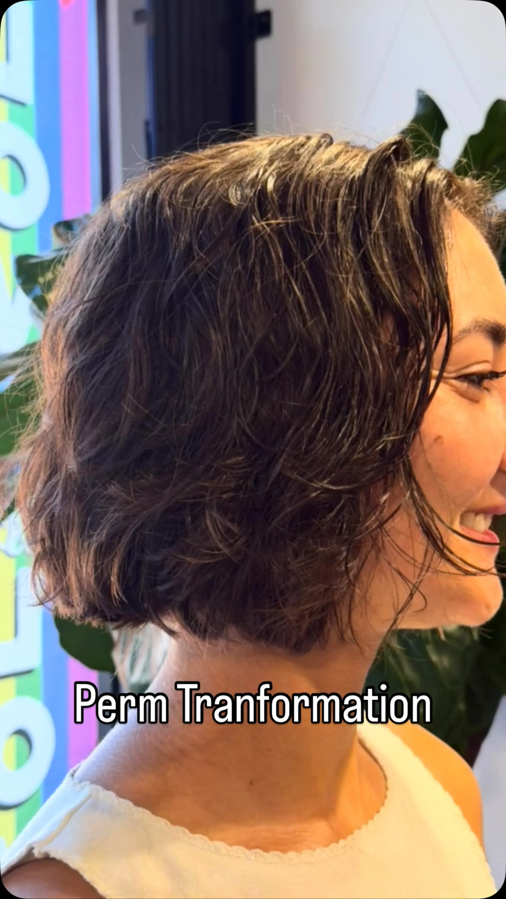 A chin-length French bob styled with tousled, soft wavy texture from a modern perm. 1