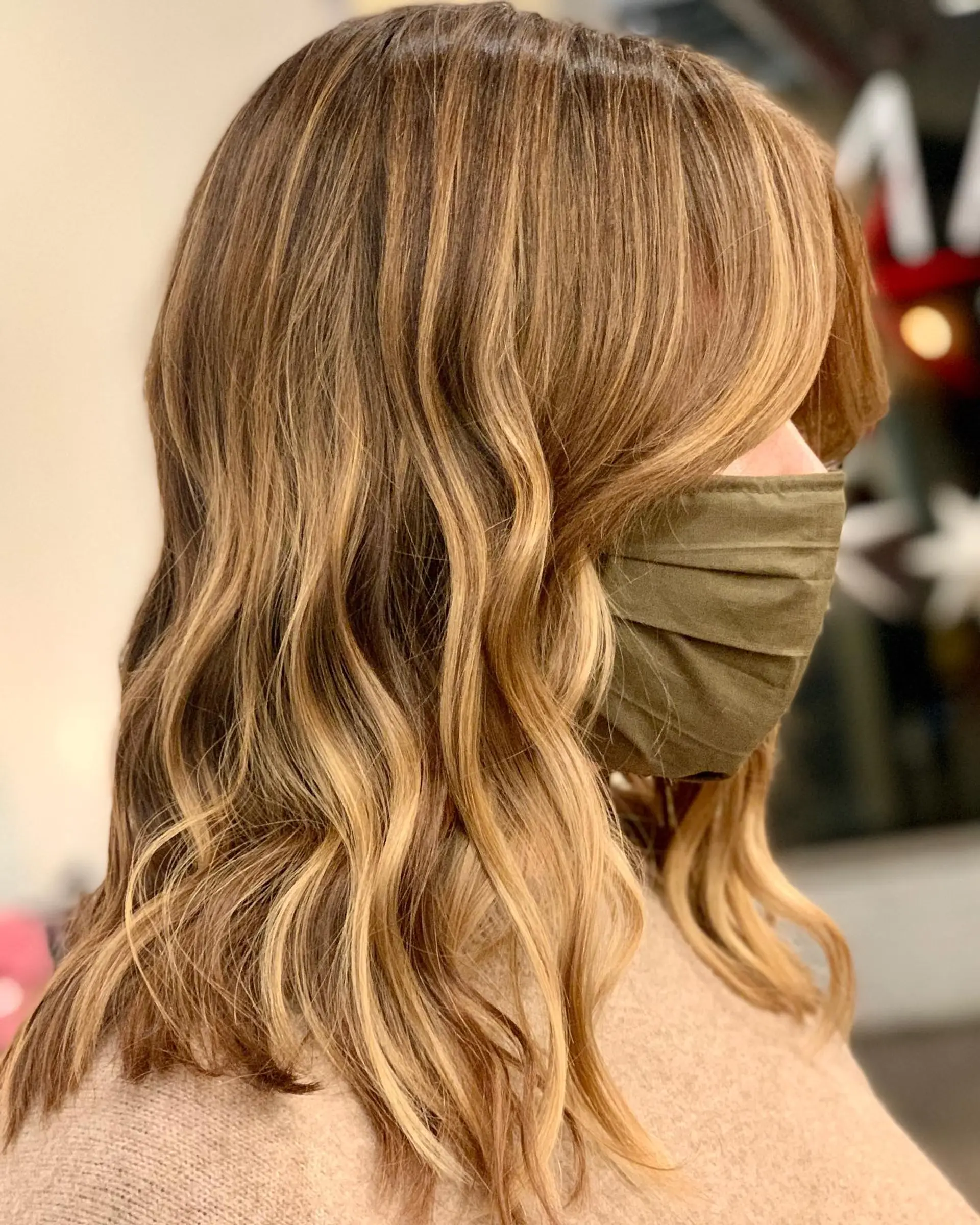A stunning wavy hairstyle featuring a caramel swirl balayage. 1