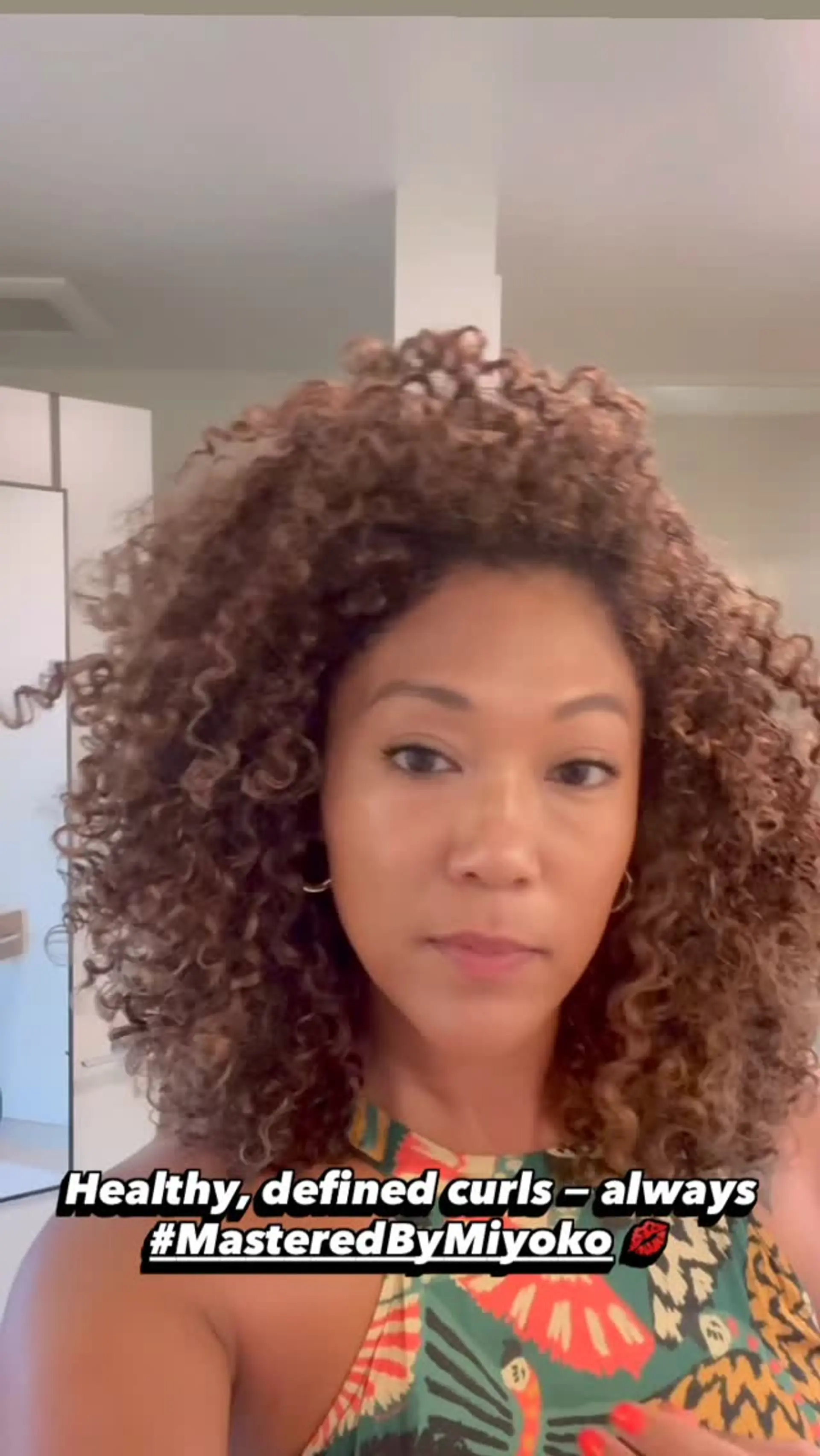 Voluminous, shoulder-length curls with soft bounce and healthy definition. 1
