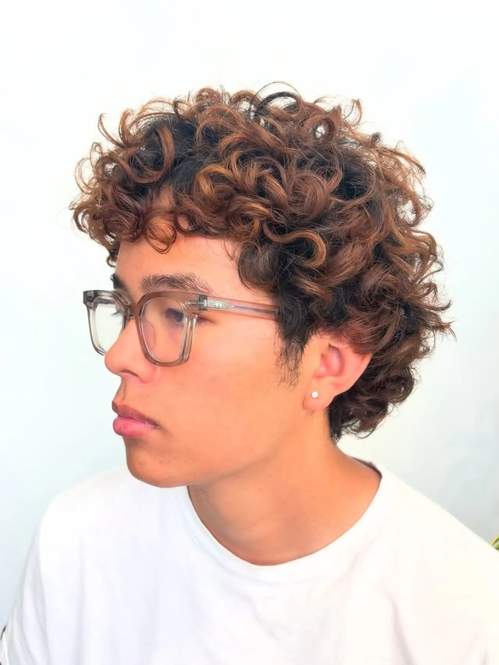 A short, textured curly hairstyle. 1