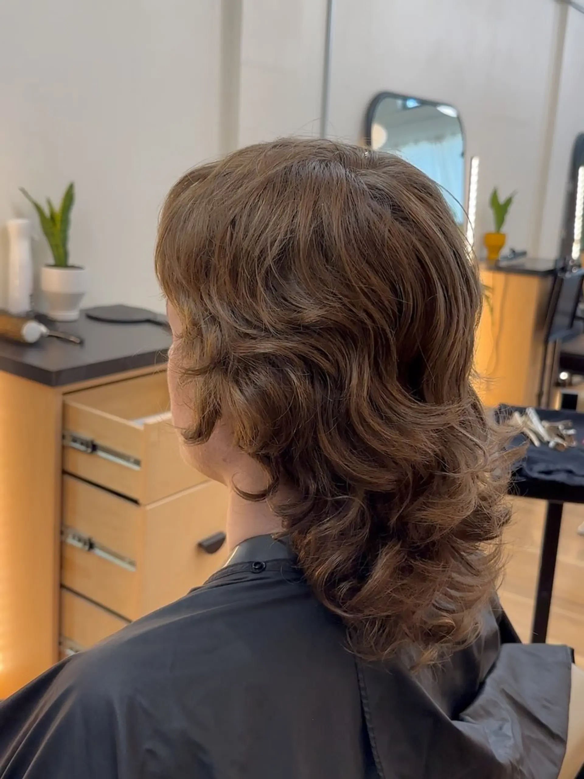 A textured medium-length shag haircut with soft natural waves, feathered layers, and volume. 1